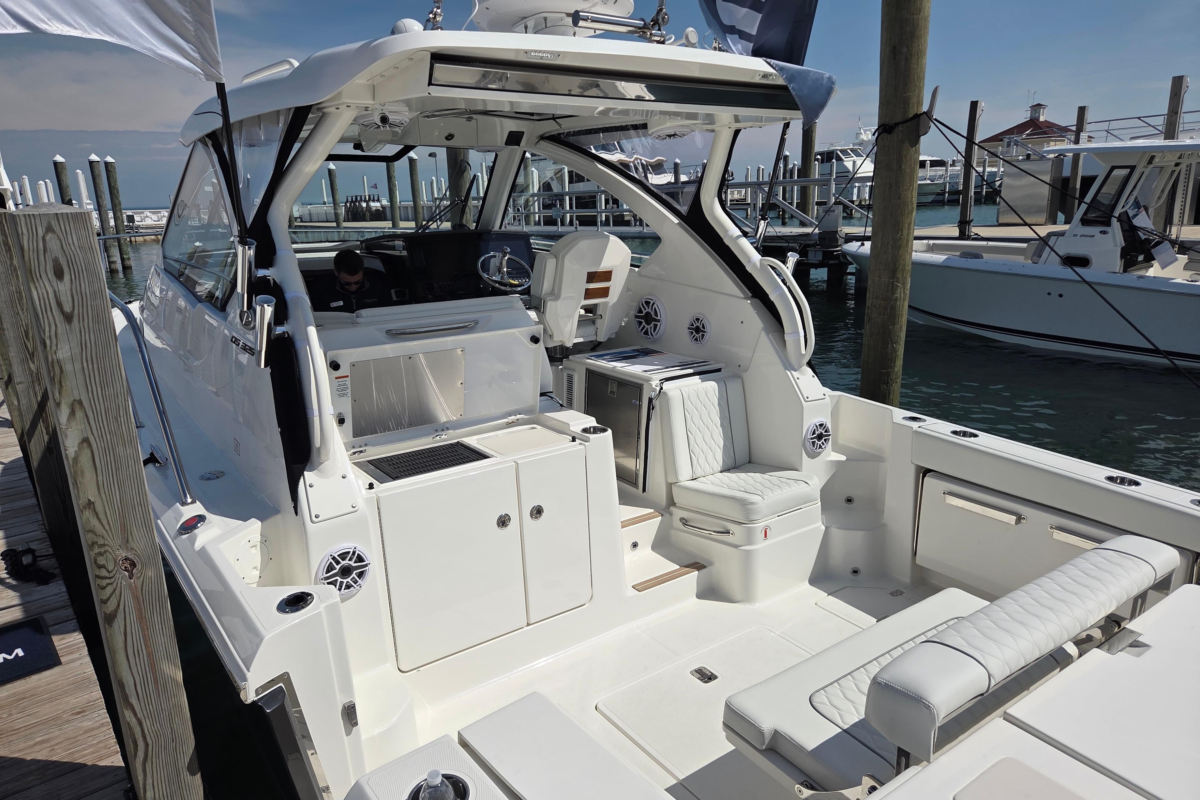 2026 Pursuit OS 325 Offshore boat docked, featuring spacious seating and modern amenities.