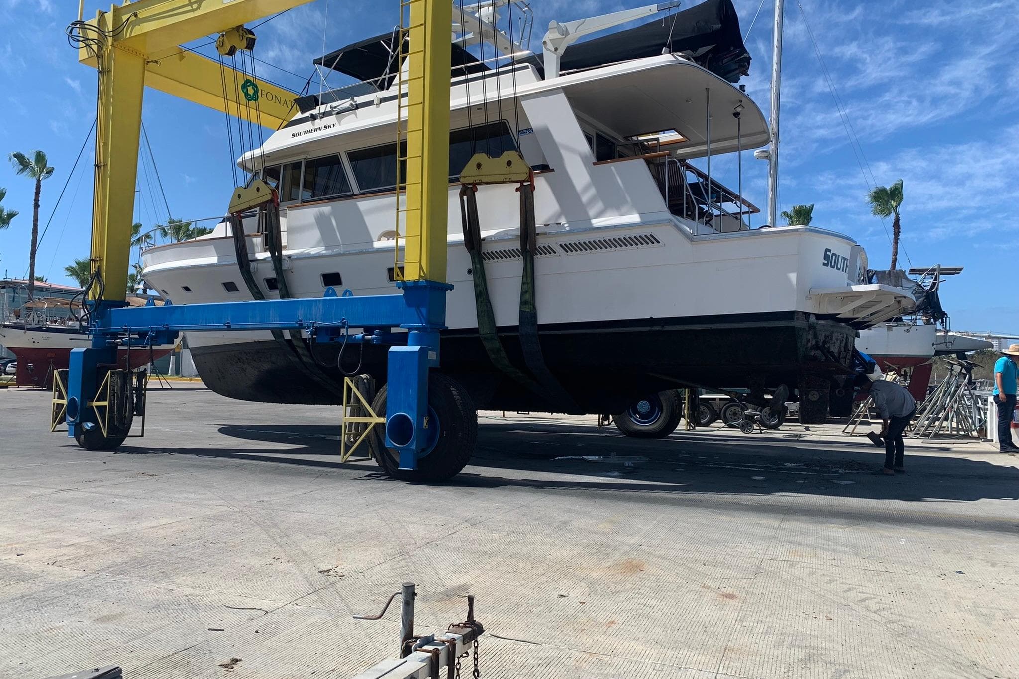 Southern Cross 53 yacht from 1987 being lifted by a boat hoist.