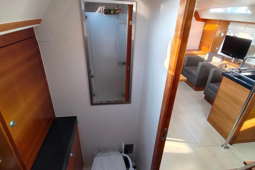 Interior of 2007 Hanse 470e yacht, featuring modern wood finishes and a cozy living area.