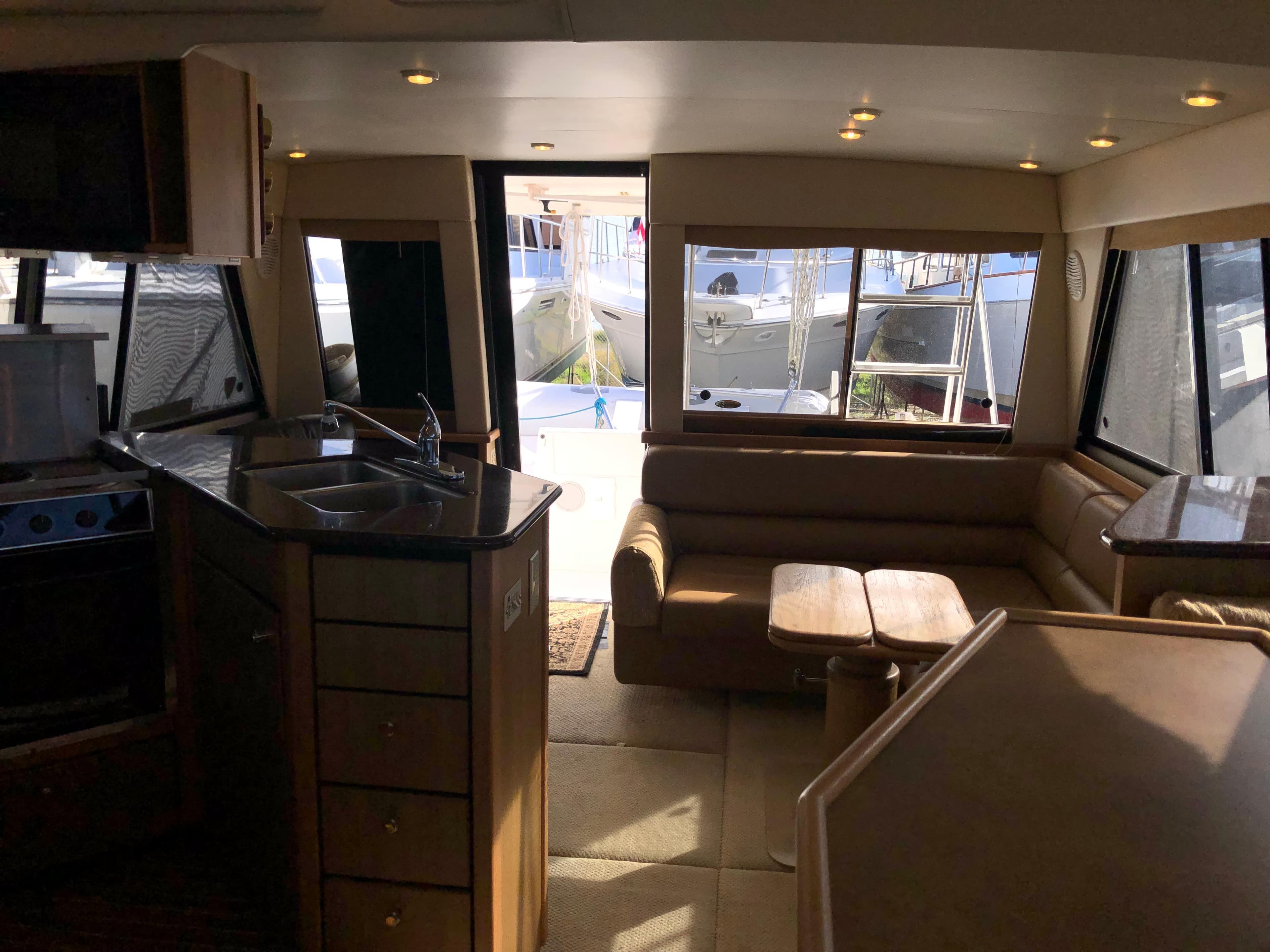 Interior of 2002 Bayliner 39 Motor Yacht with kitchen and seating area.