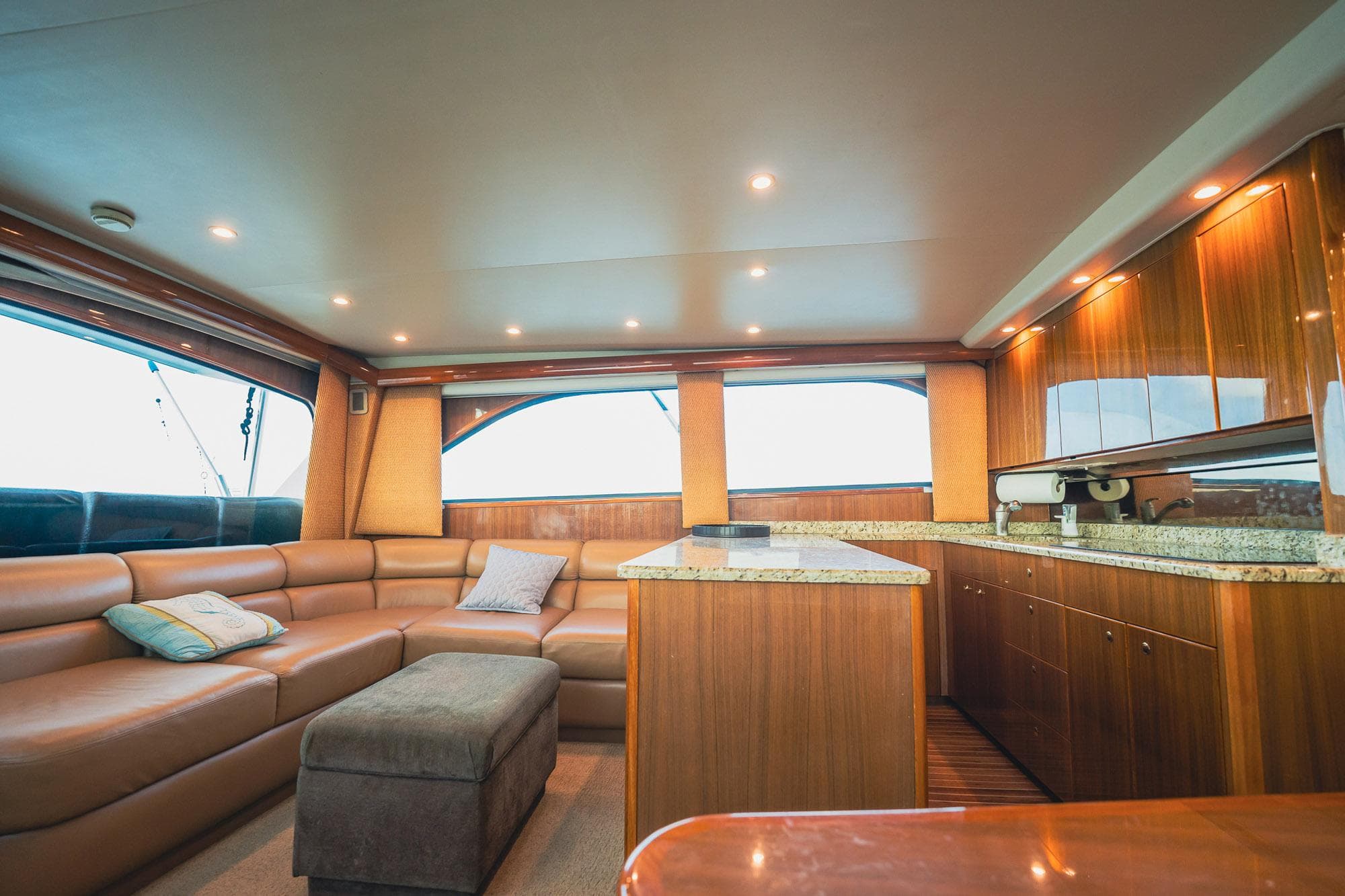 Luxurious interior of a 2005 Viking 48 Convertible yacht with plush seating and wood finishes.