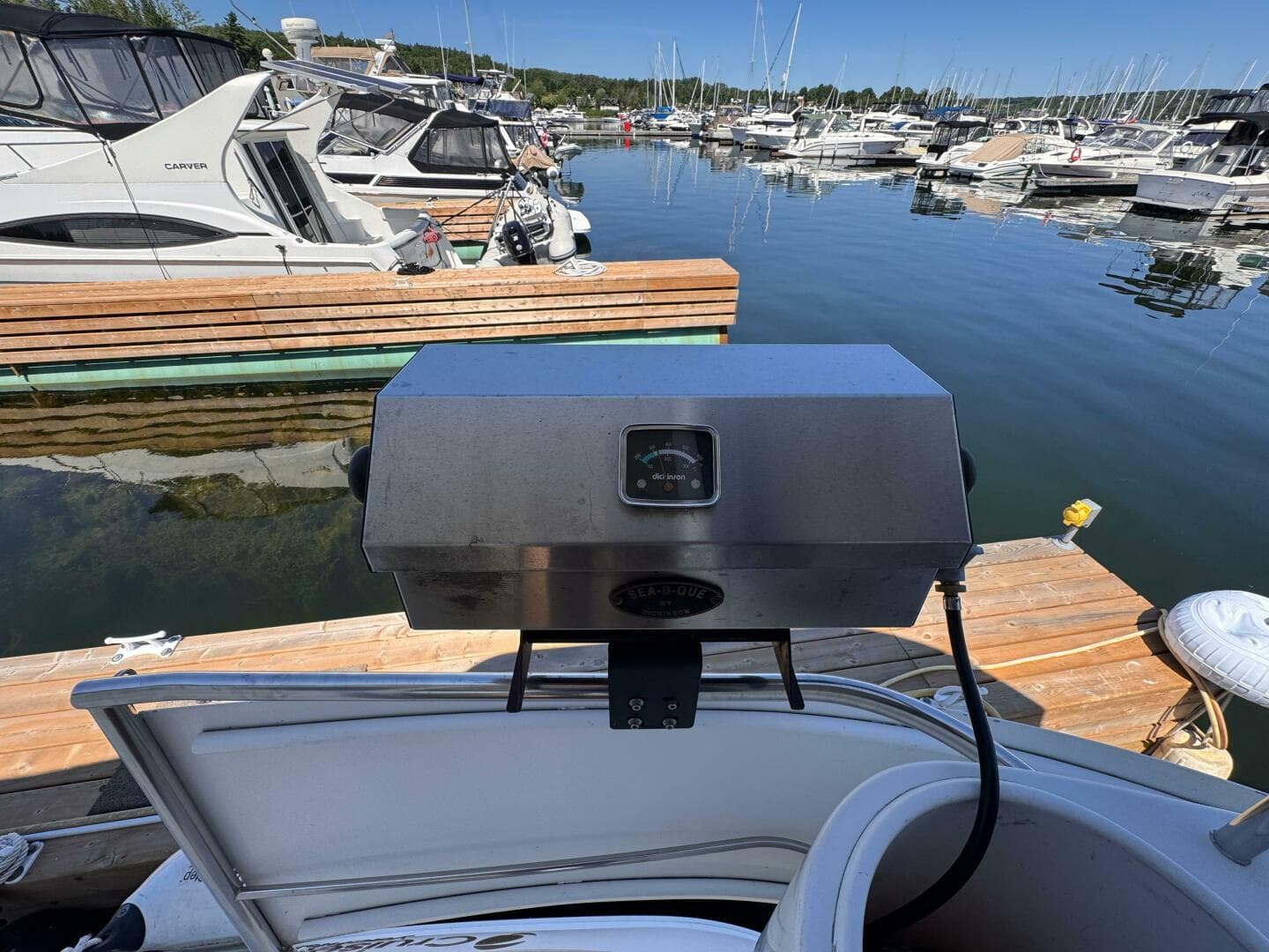 Outdoor grill on a 2002 Cruisers Yachts 4450 Express Motor Yacht at a marina.