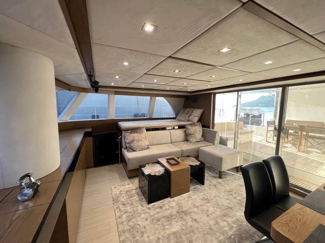 Luxurious interior of 2015 Sunreef 60 LOFT yacht with modern furnishings and large windows.