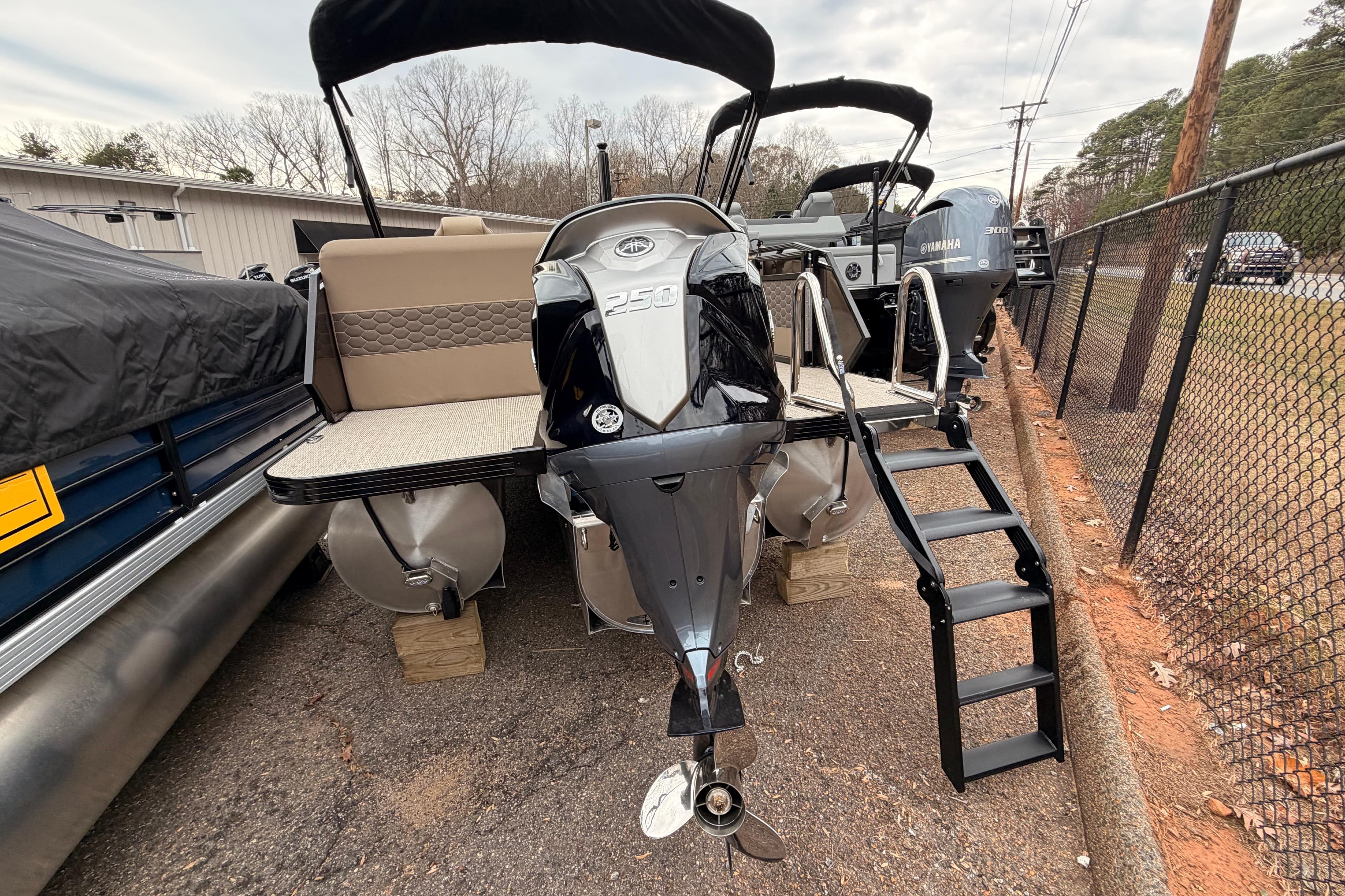 2026 Veranda VR 235 L pontoon boat with Yamaha 250 engine, docked with ladder.