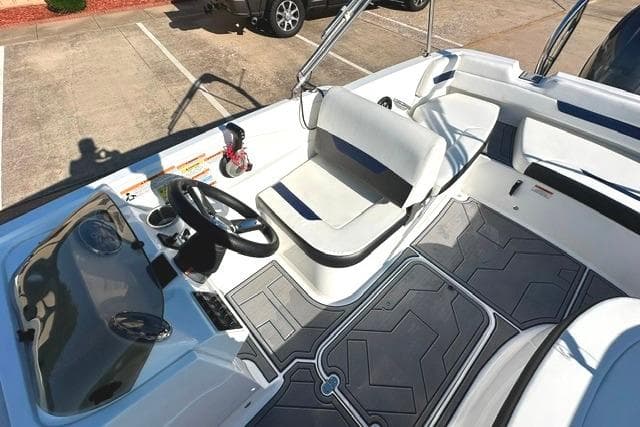 2021 Hurricane SunDeck Sport 185 OB boat interior with steering wheel and seating area.