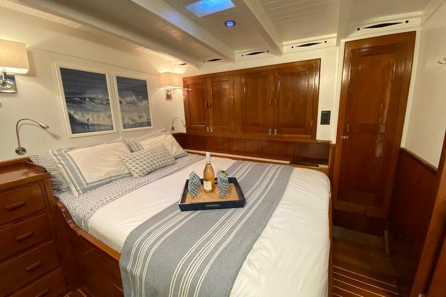 Luxurious 1939 William McMeek Brooks Marine yacht bedroom with elegant wood finish.