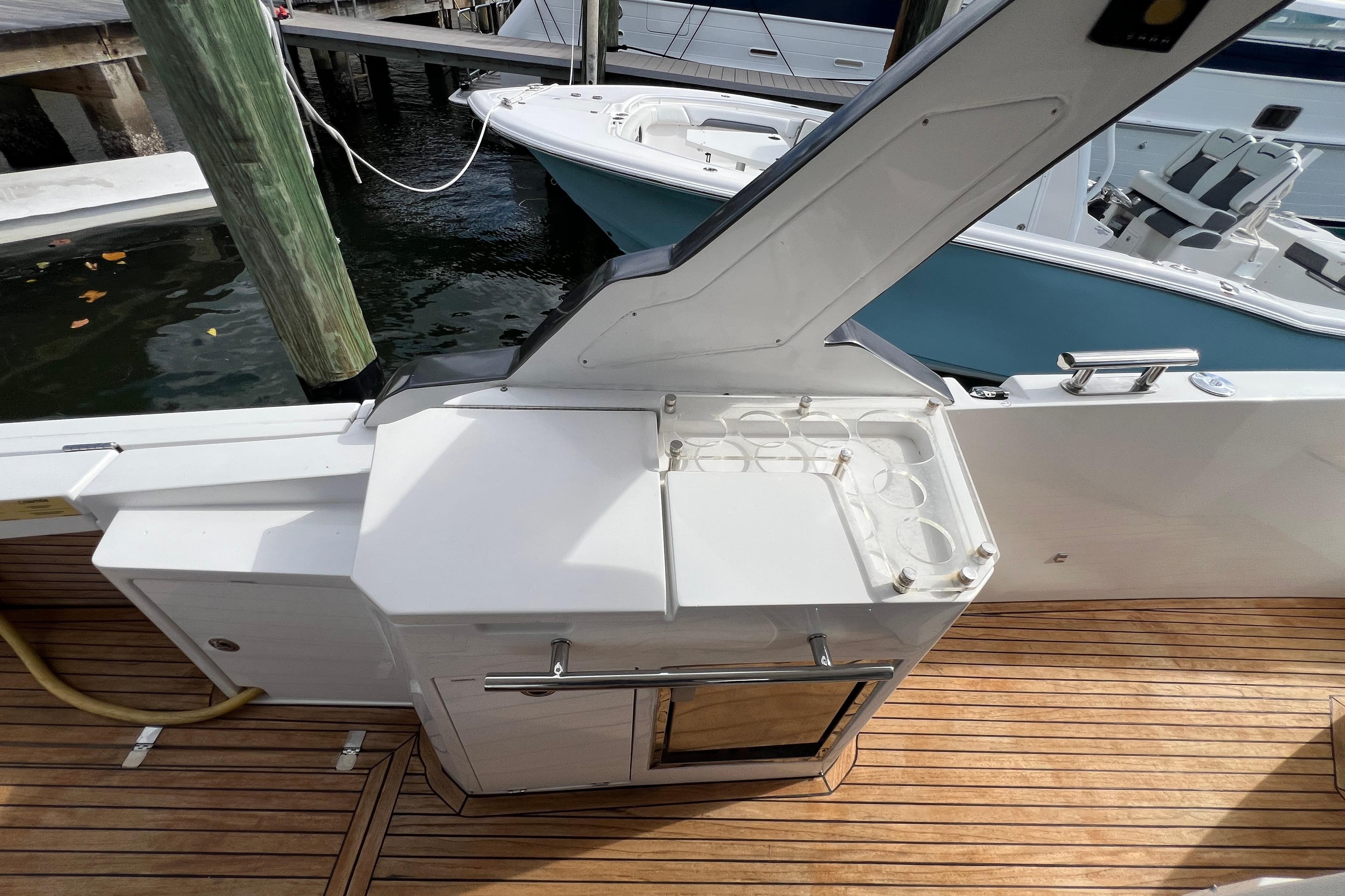 2018 Azimut Verve 40 yacht deck with outdoor kitchenette and wooden flooring.