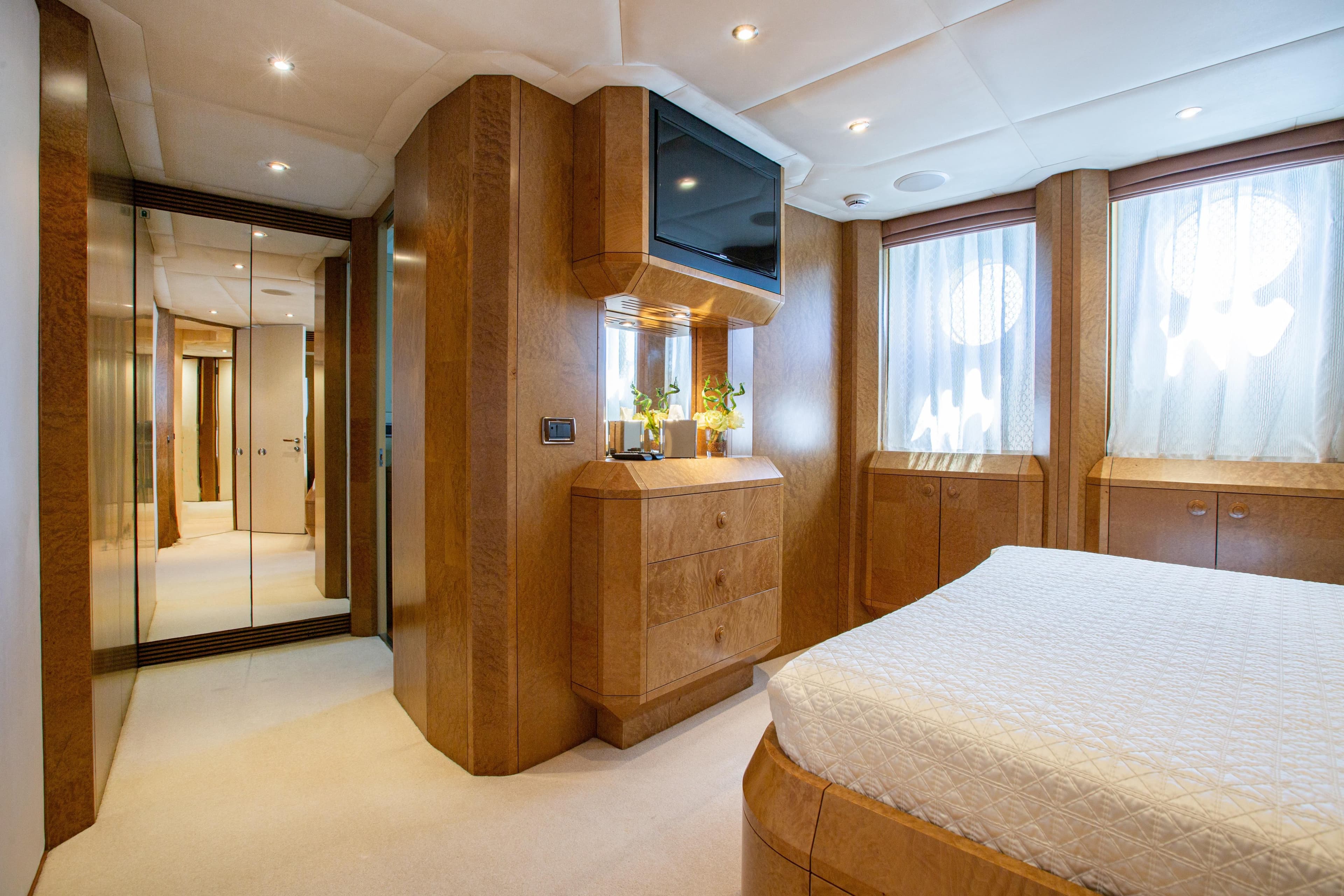 Luxurious 2005 Evolution Yachts Custom bedroom with wood accents and modern amenities.