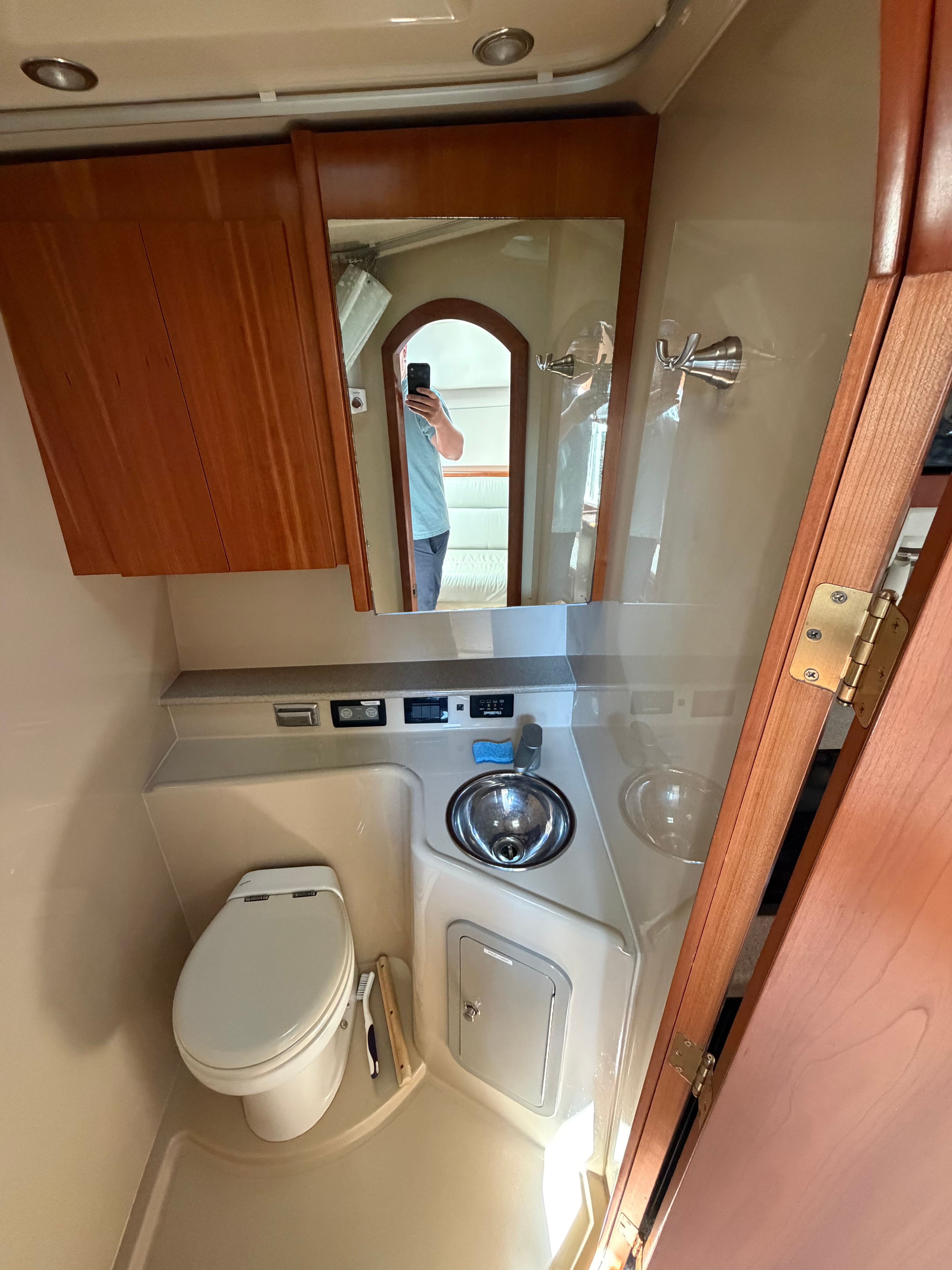 Interior of 2005 Rampage 33 Express with bathroom and wooden cabinets.