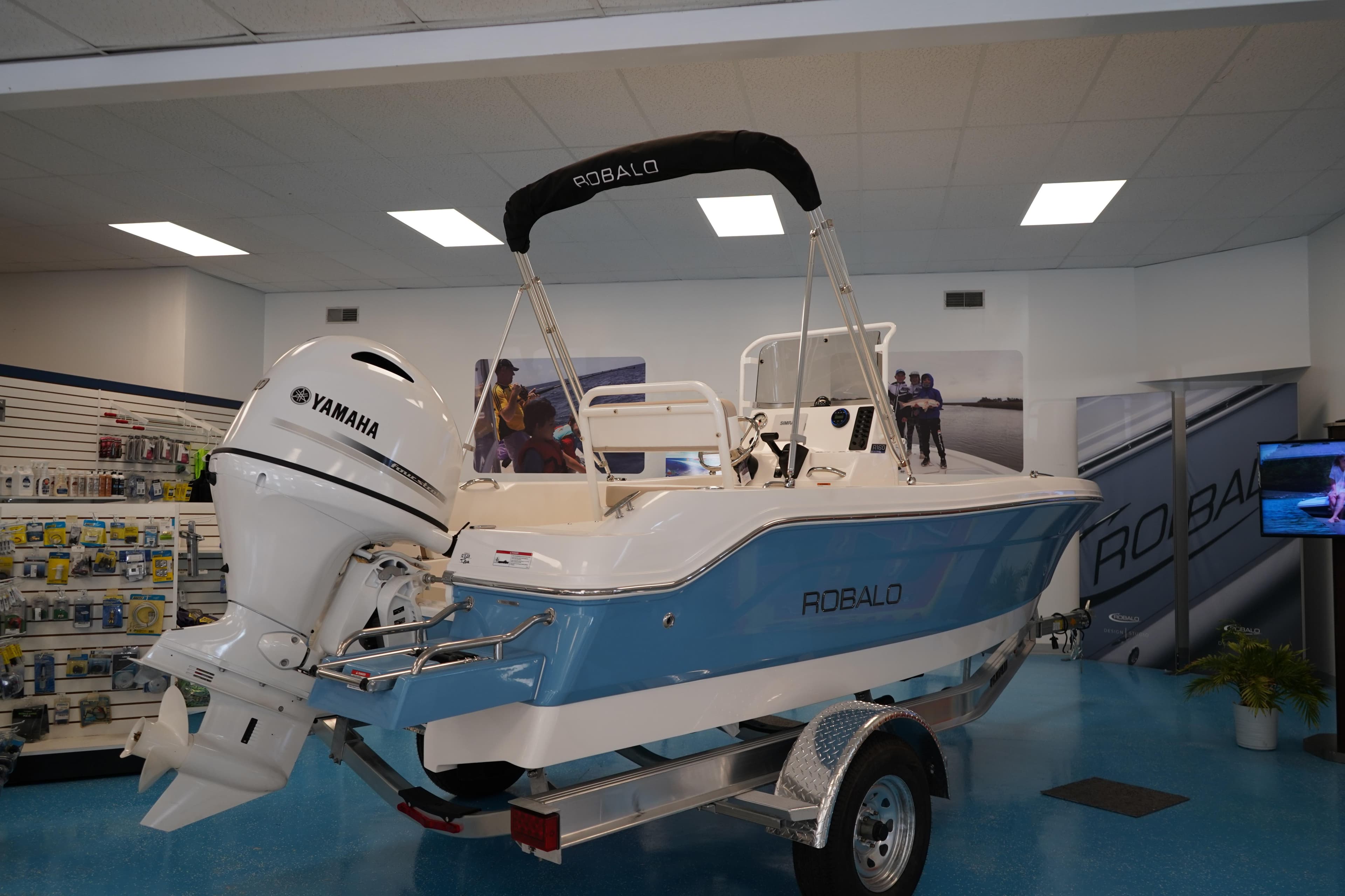 2026 Robalo R160 Center Console boat with Yamaha engine in showroom.