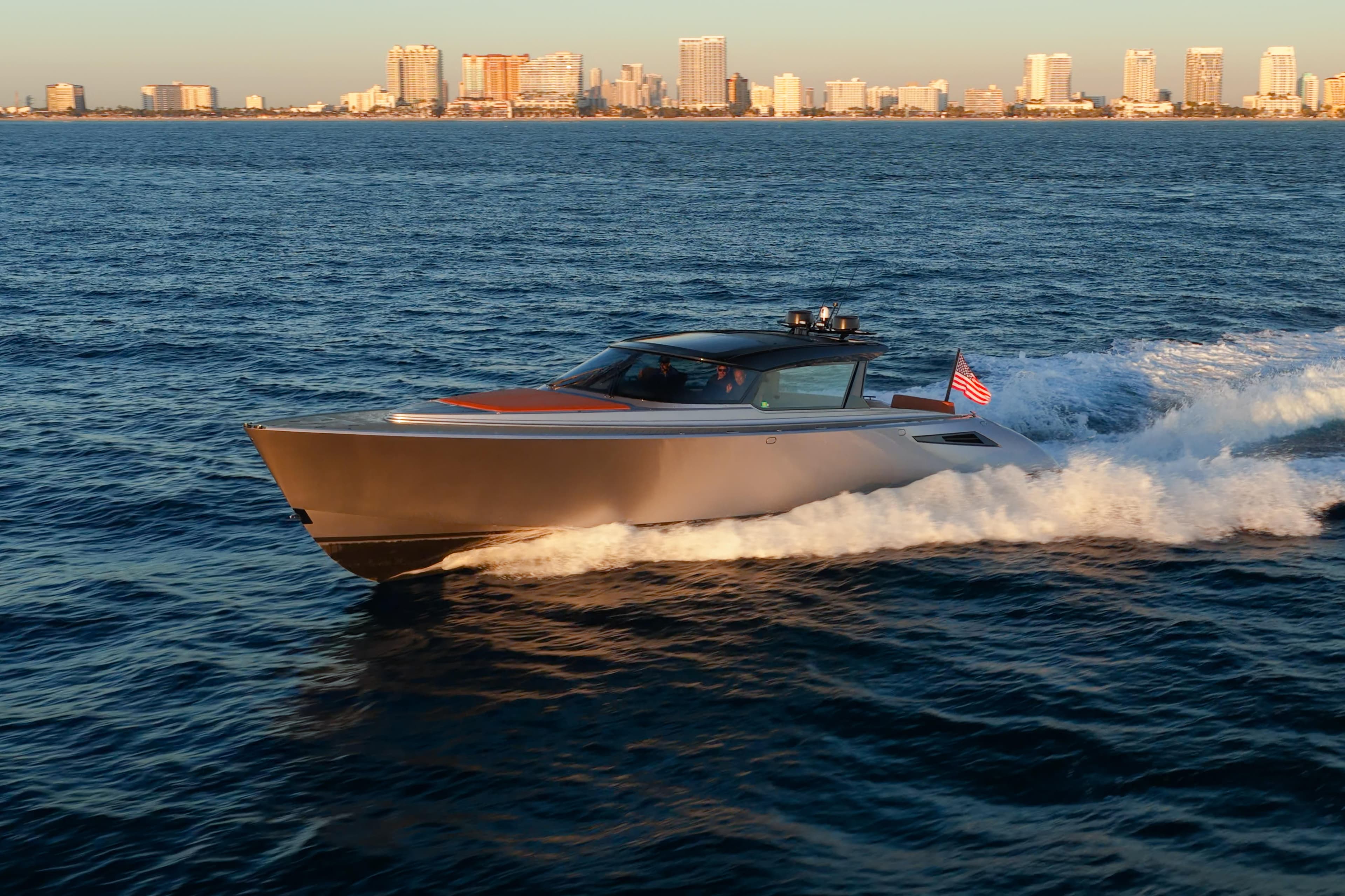2024 Wajer 55 HT yacht cruising on ocean with city skyline in background.
