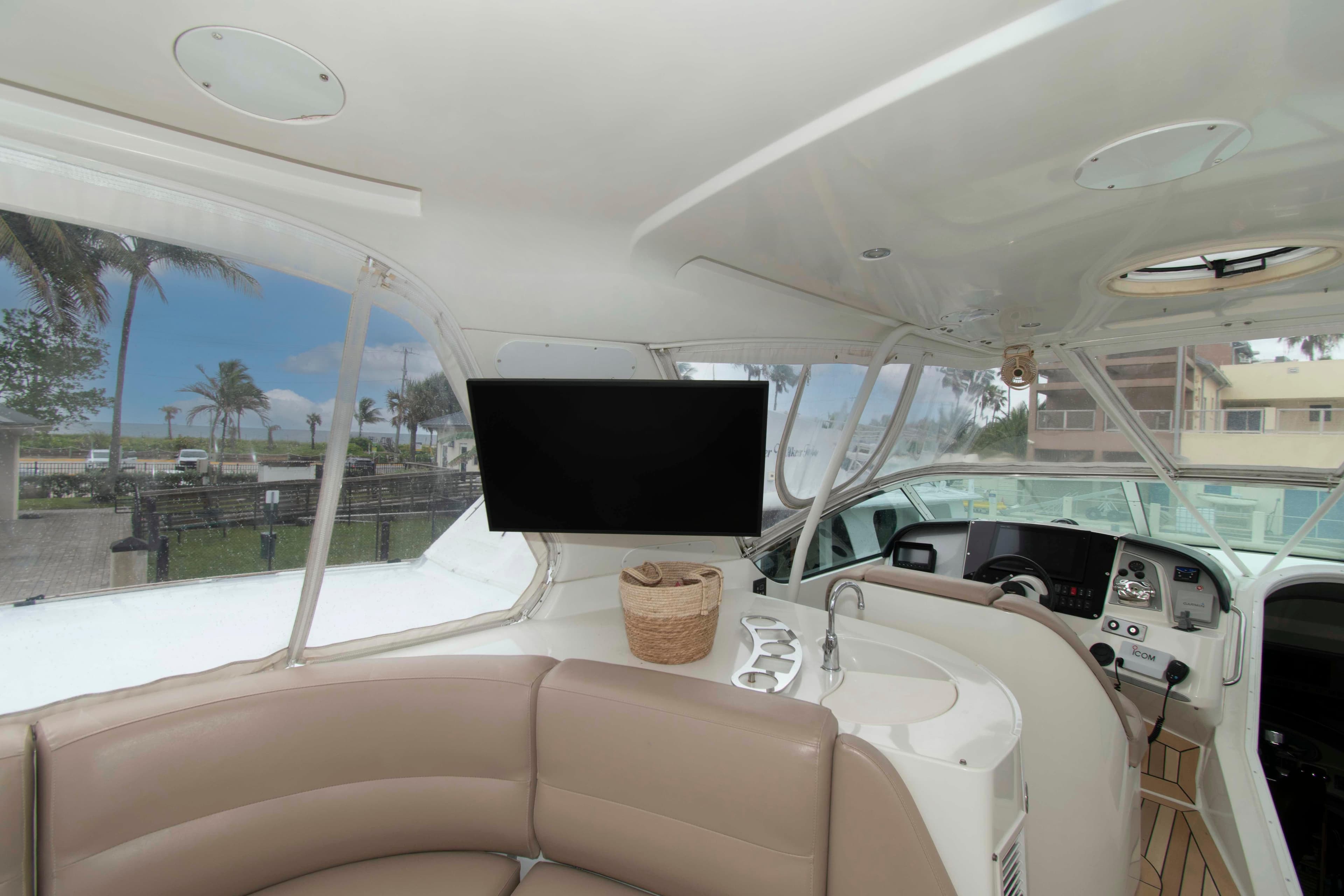 Interior of 2007 Carver 56 Voyager yacht with helm, seating, and TV.
