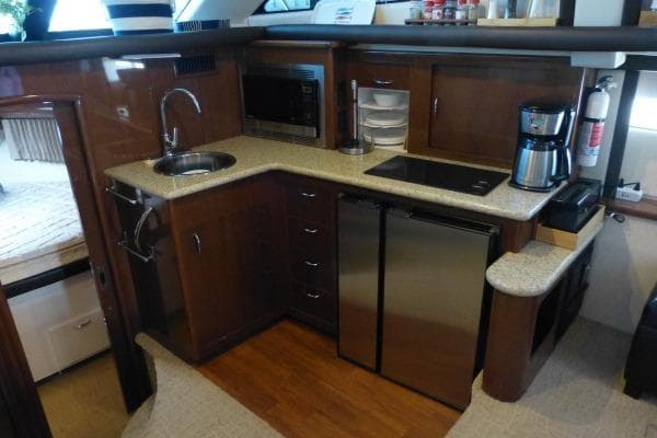 2009 Carver 41 Cockpit Motor Yacht kitchen with modern appliances and wood cabinetry.