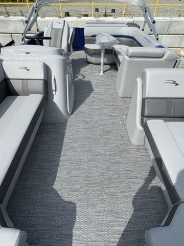 2023 Bennington 20 SXL pontoon boat interior with gray seating and carpet.