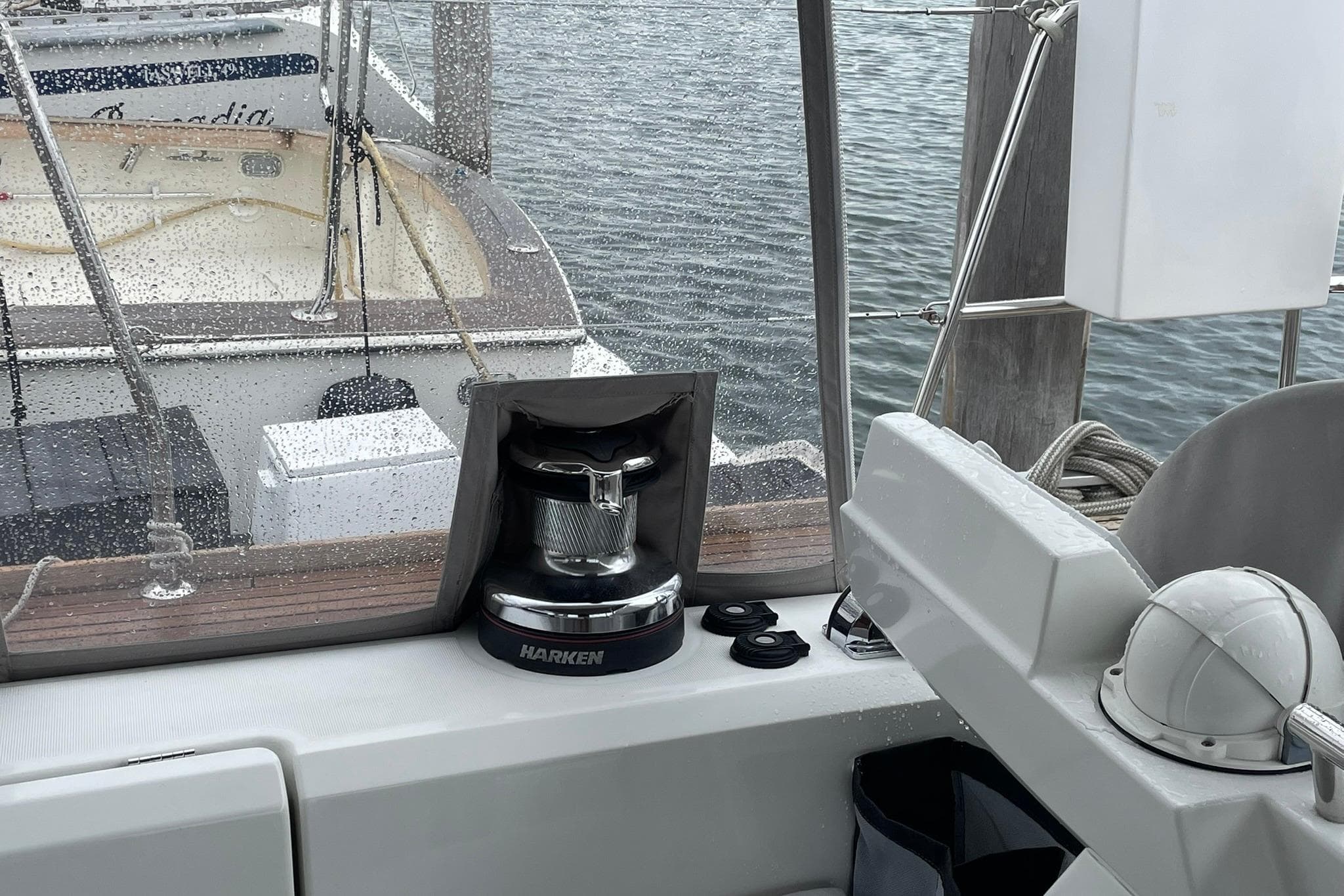 Cockpit view of 2017 Beneteau Sense 57 yacht with Harken winch and marina backdrop.