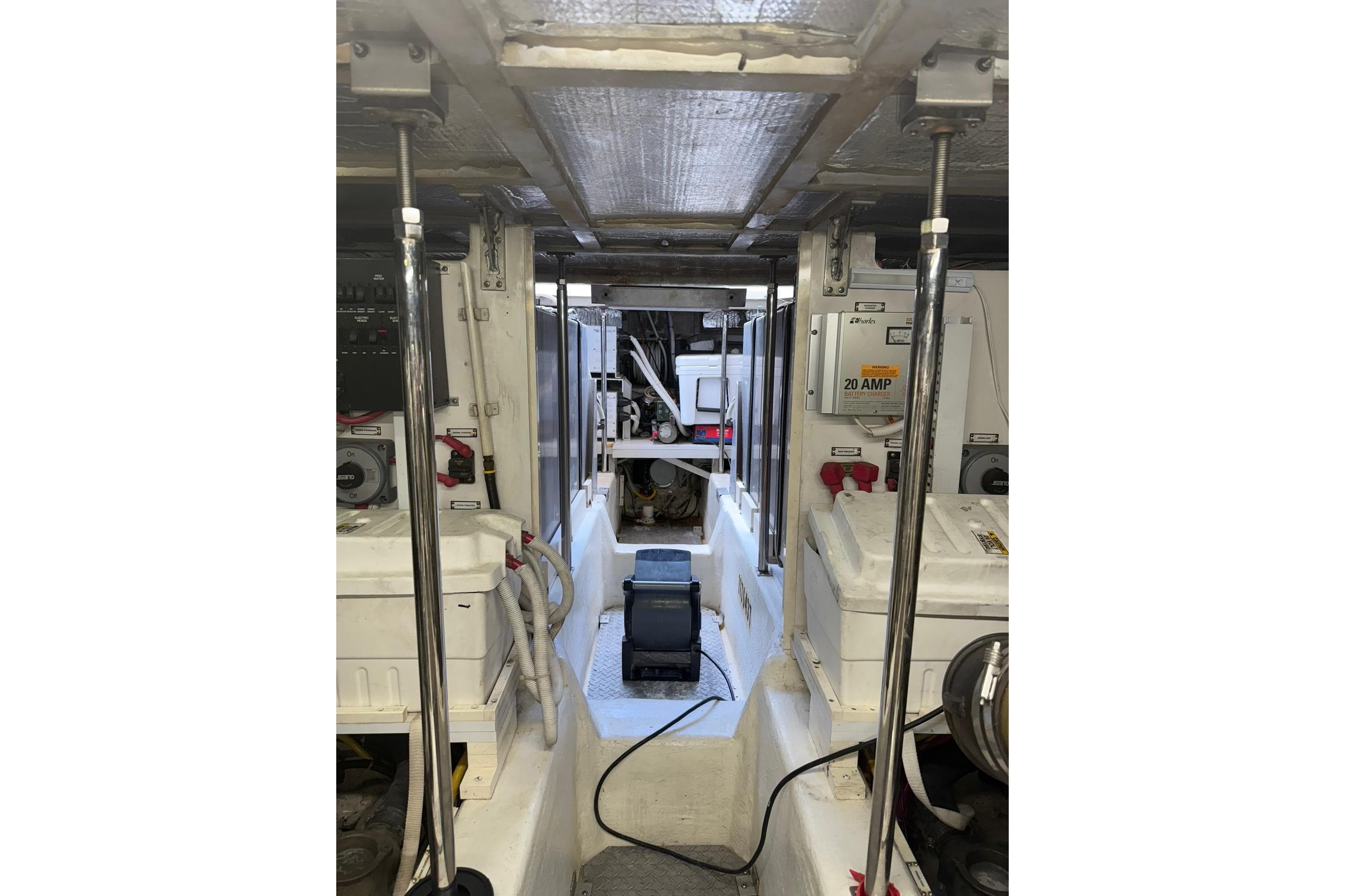 Engine room of a 2006 Carver 56 Voyager yacht, showcasing equipment and wiring.
