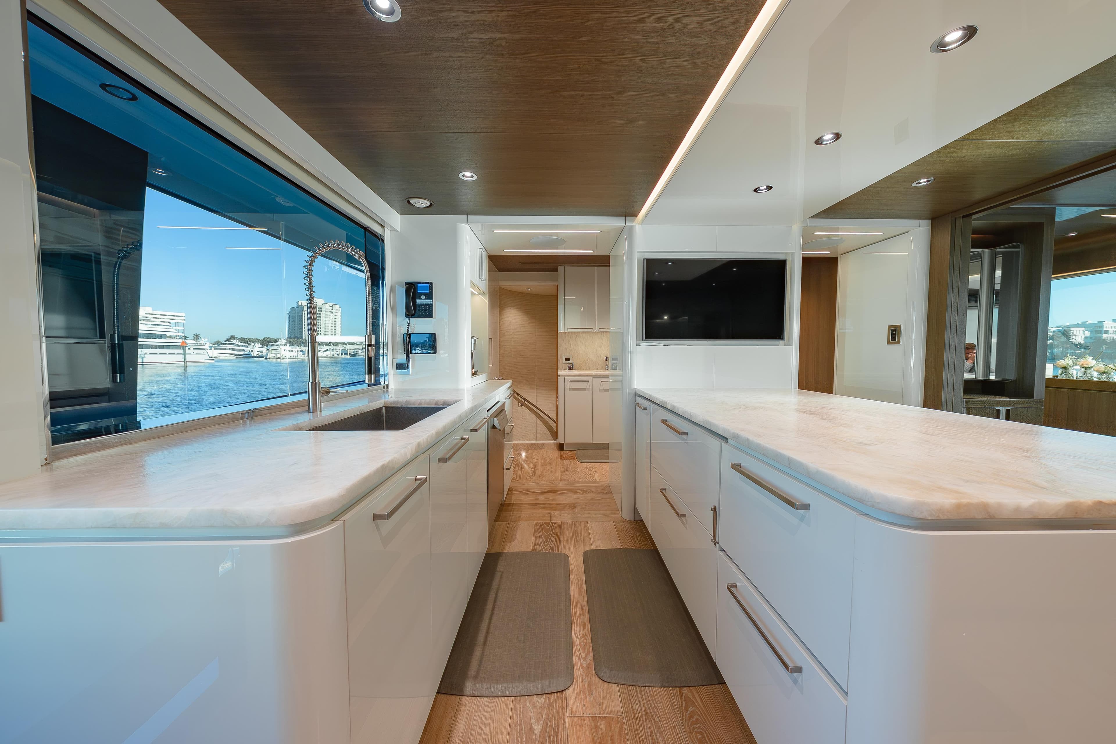 Luxurious 2018 Westport Raised Pilothouse yacht kitchen with modern design and waterfront view.
