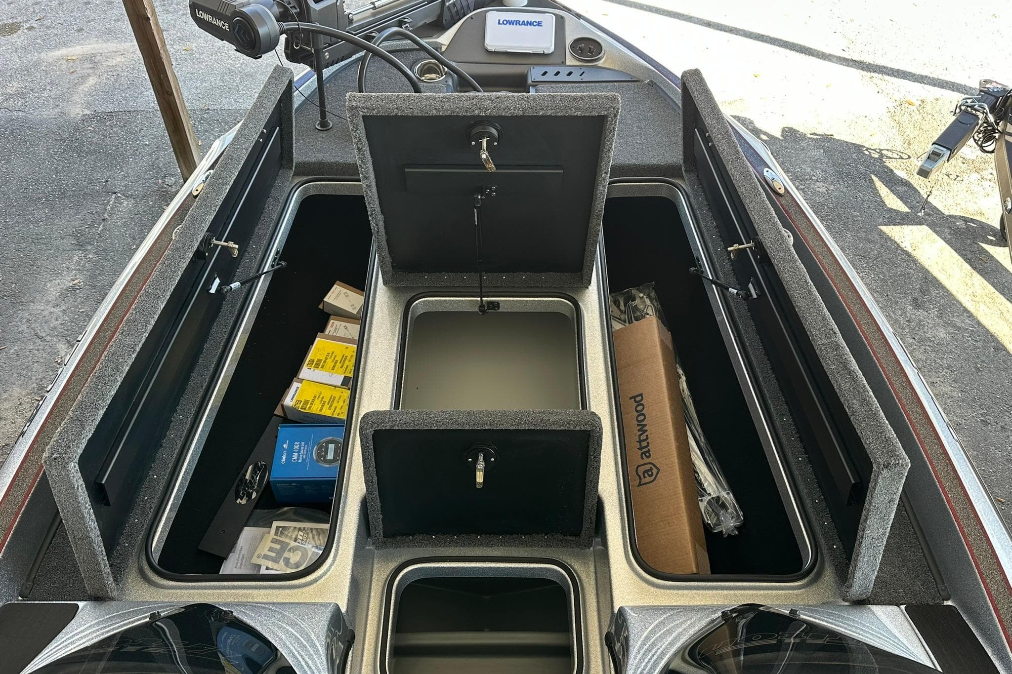 2026 Triton 179 TrX boat storage compartments with fishing gear and equipment.