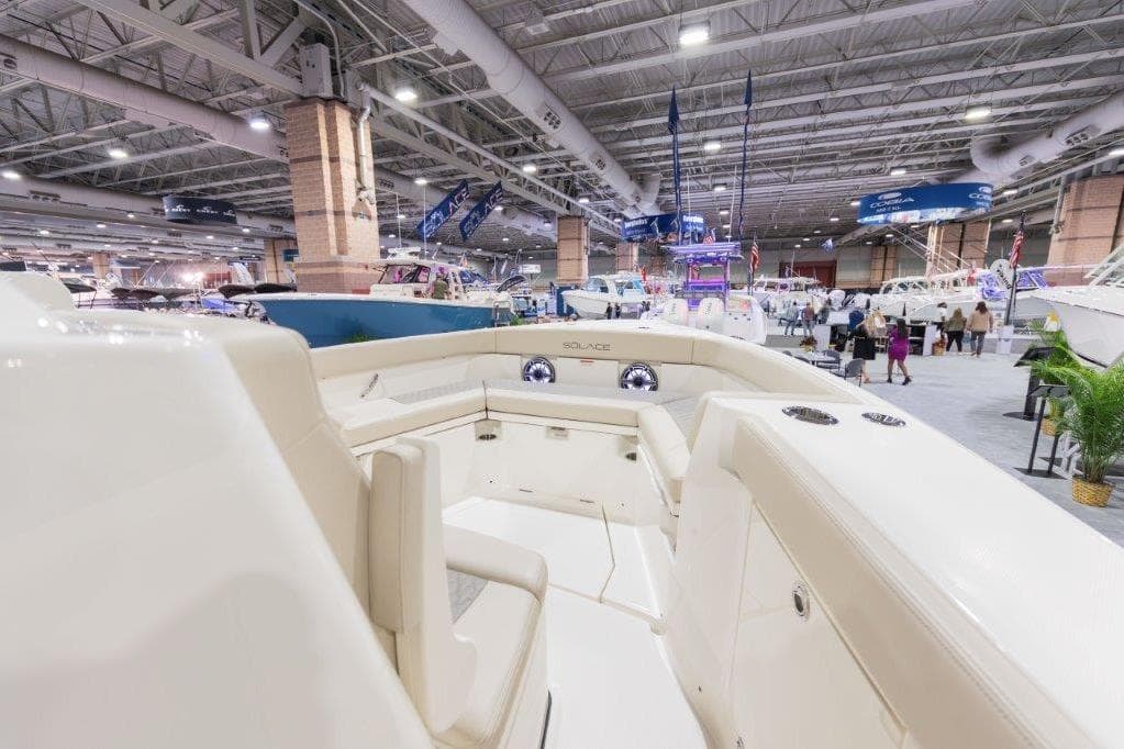 2026 Solace 30 CS boat interior at an indoor boat show, showcasing luxury seating.