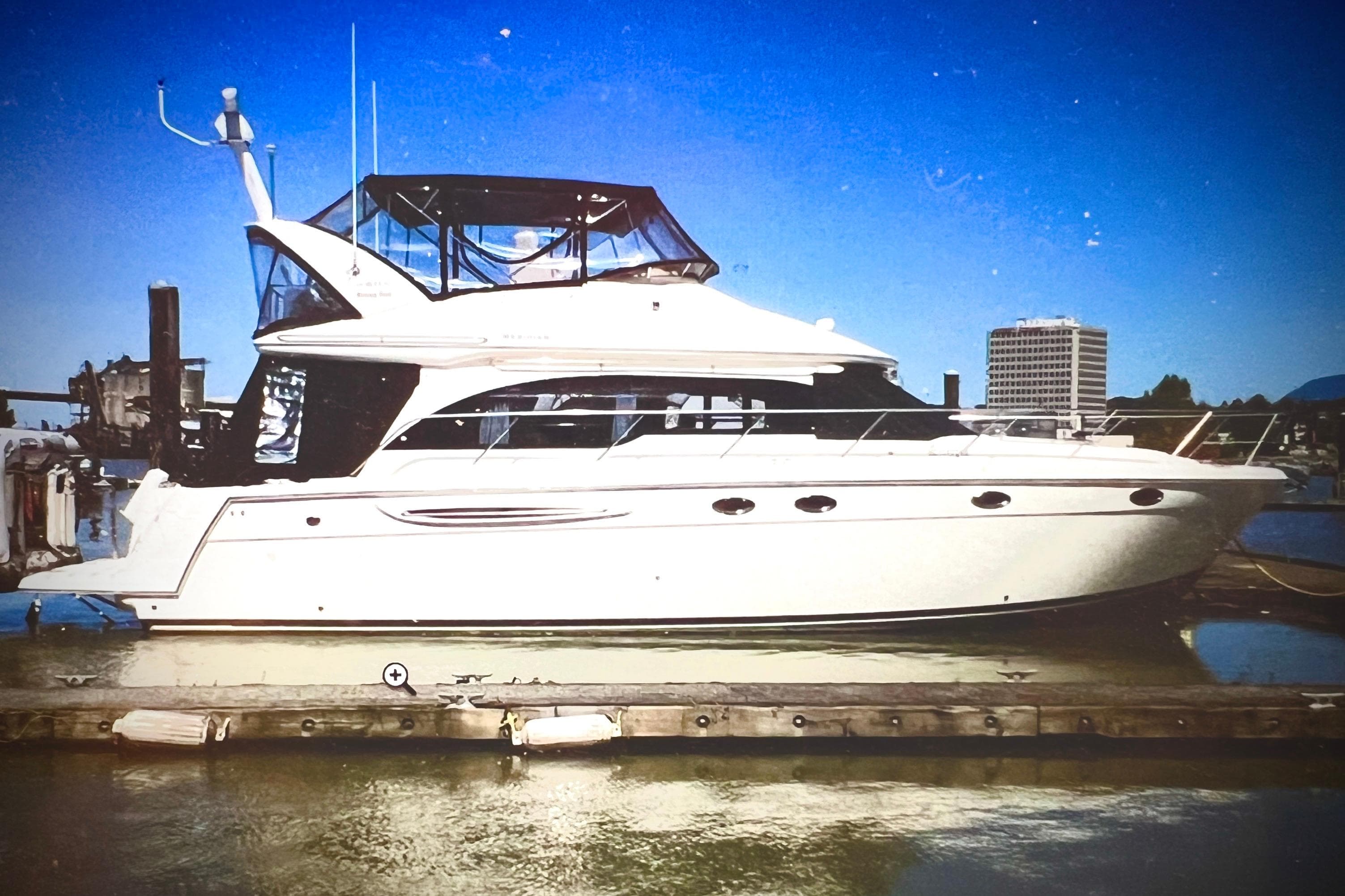 2007 Meridian 411SB yacht docked at marina under clear blue sky.