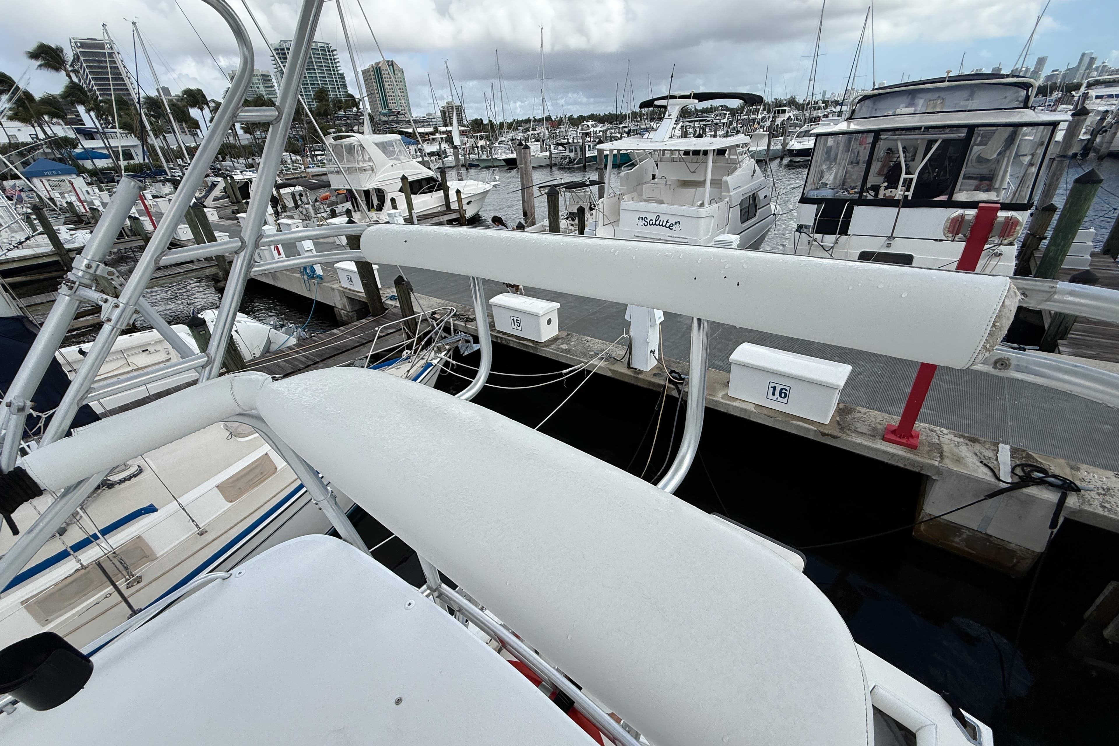 1998 Cabo 31 Express yacht docked at a marina with other boats.