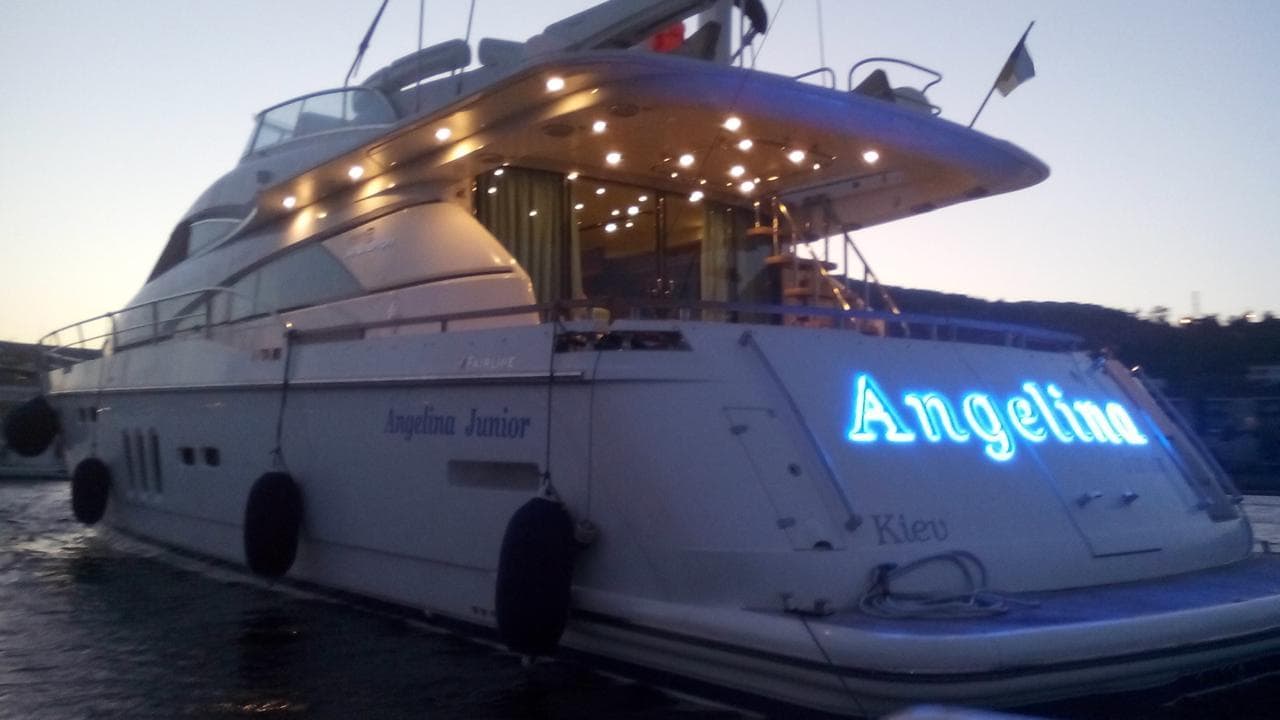 2008 Fairline Squadron 68 yacht illuminated at dusk, featuring elegant design and ambient lighting.