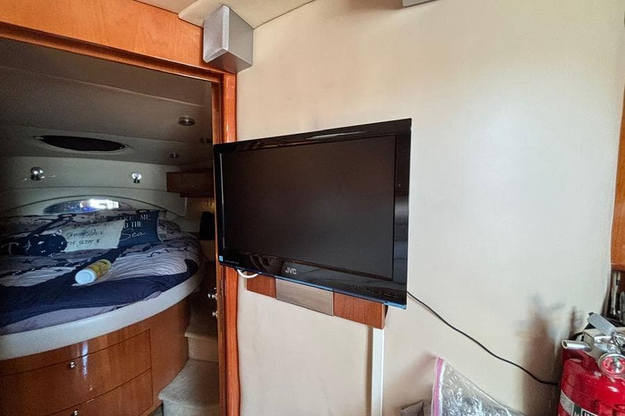 Interior of 2005 Regal Commodore 4260 yacht with TV and cozy bedroom.
