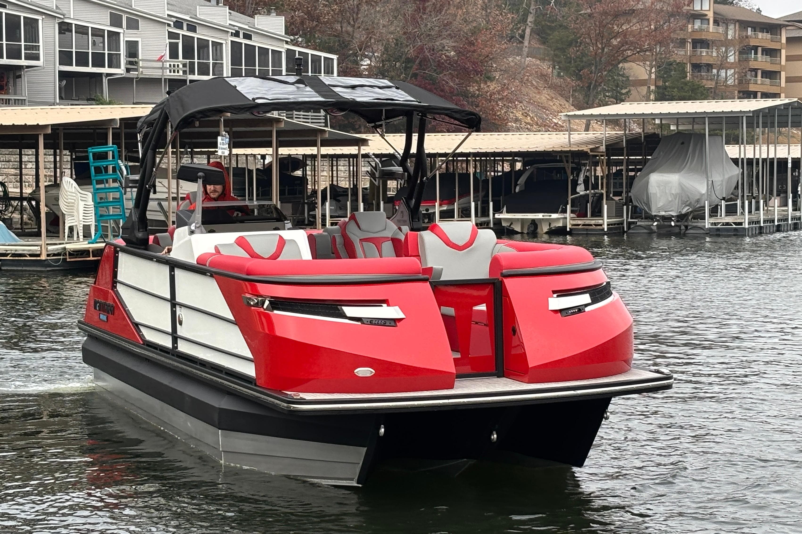 2025 Montara 25 Surf Boss boat in marina, featuring sleek red and white design.