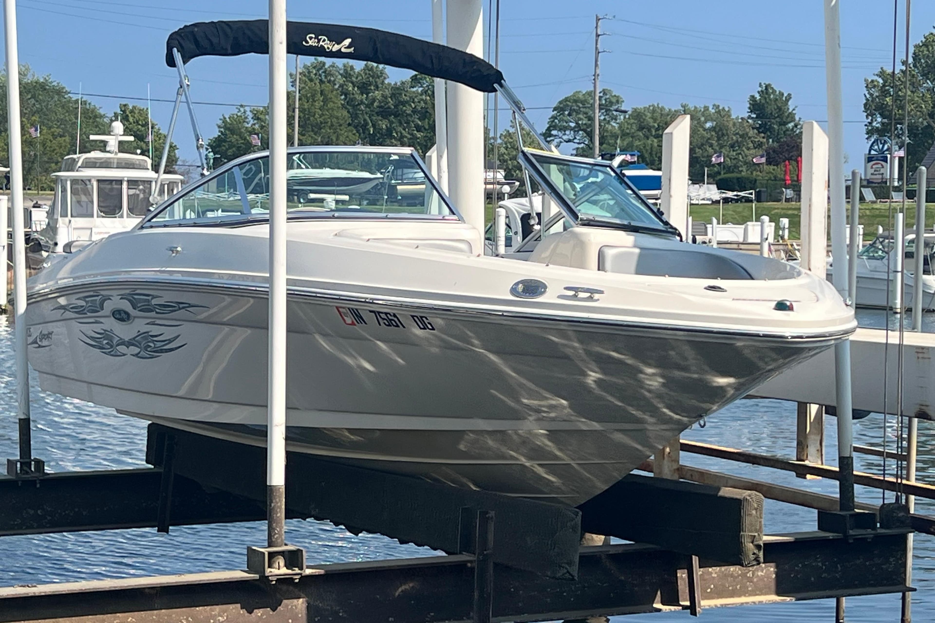 2008 Sea Ray 205 Sport boat docked at marina, featuring sleek design and graphics.