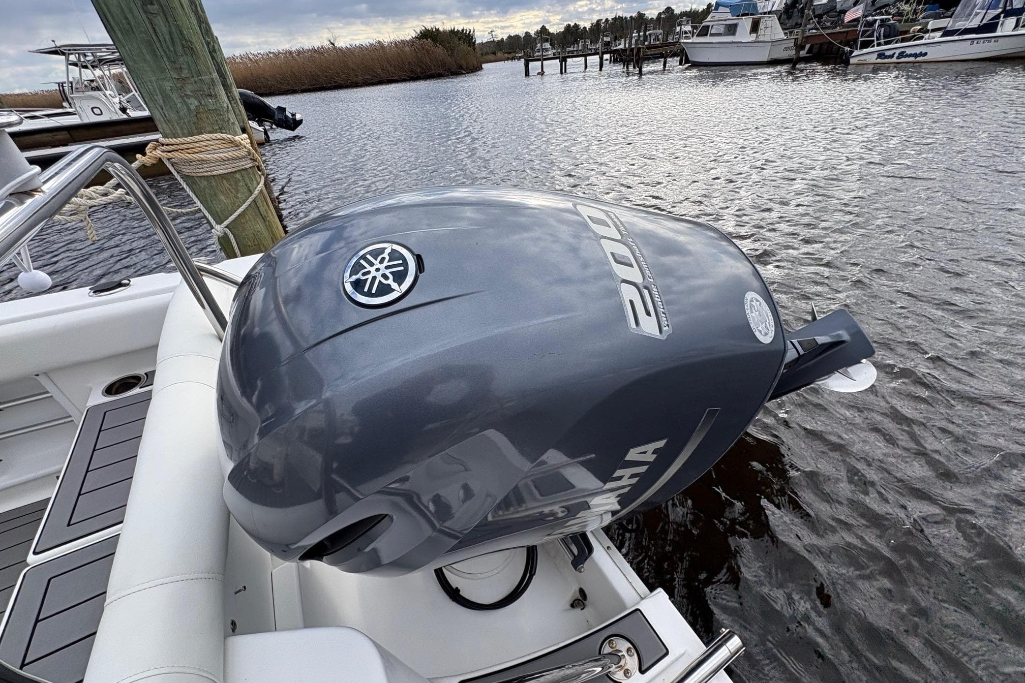 2015 Sea Hunt Ultra 234 with Yamaha 200 outboard engine docked by the water.