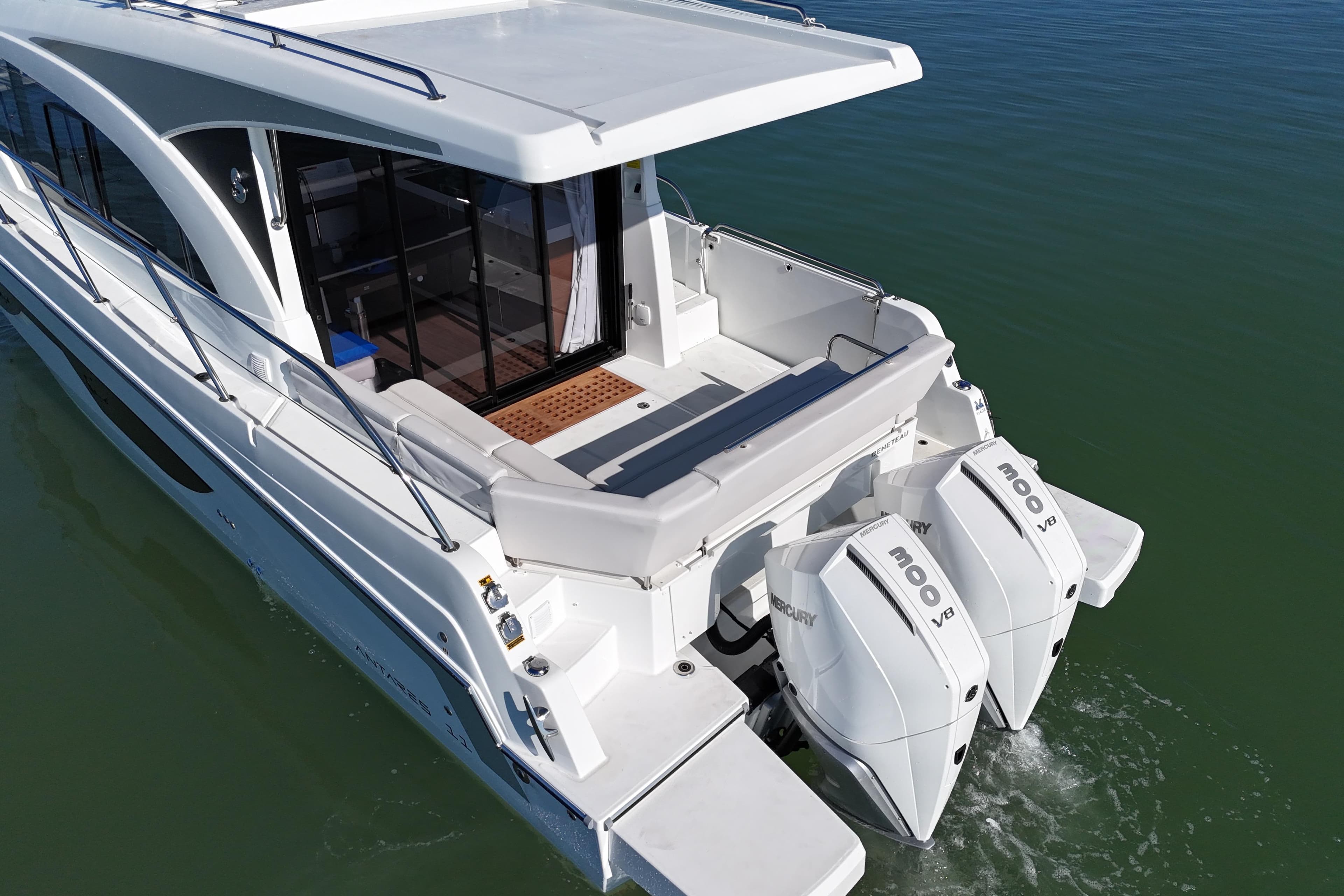 2026 Beneteau Antares 11 with dual Mercury V8 engines on calm water.