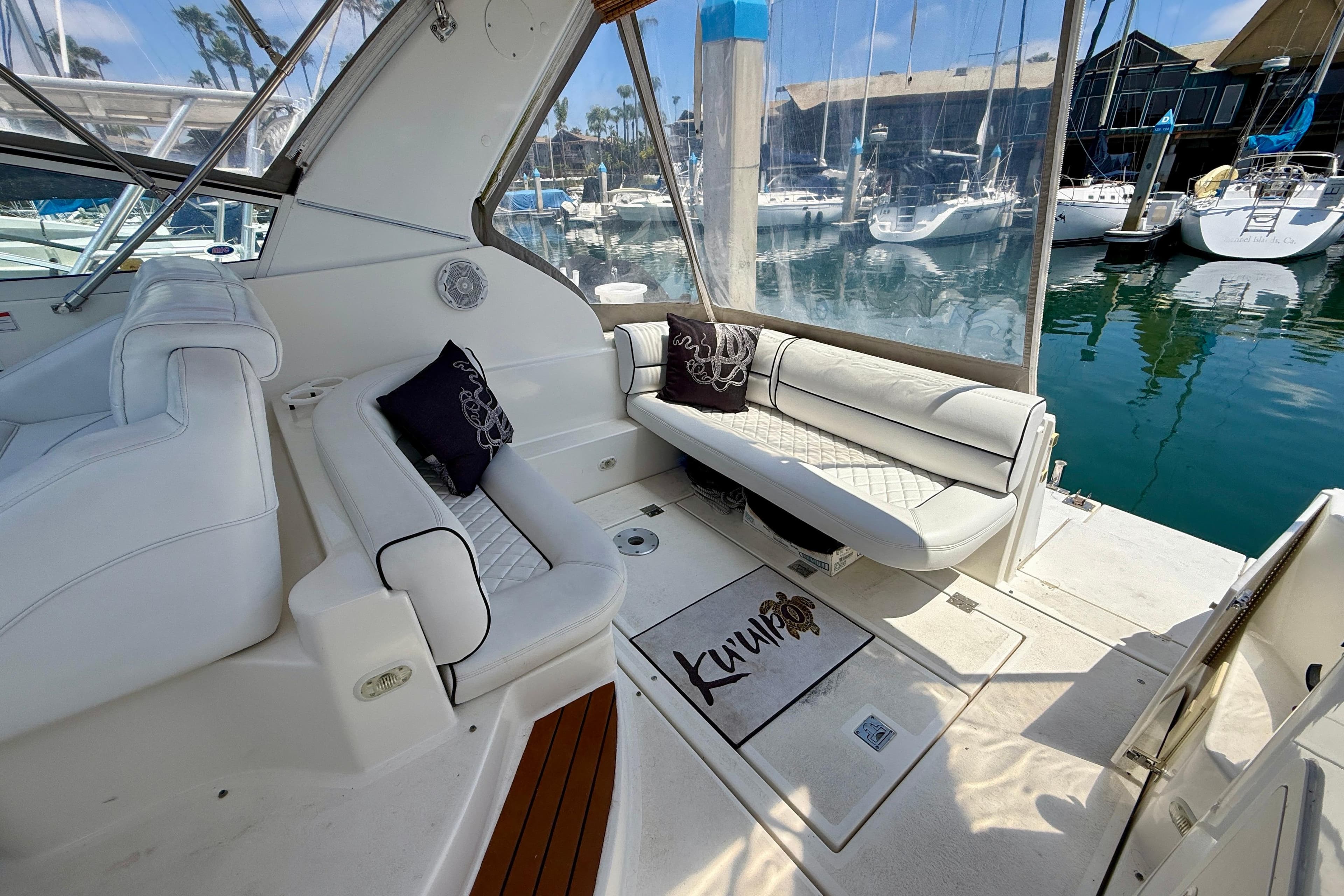 2002 Cruisers Yachts 2870 Express interior with white seating and marina view.