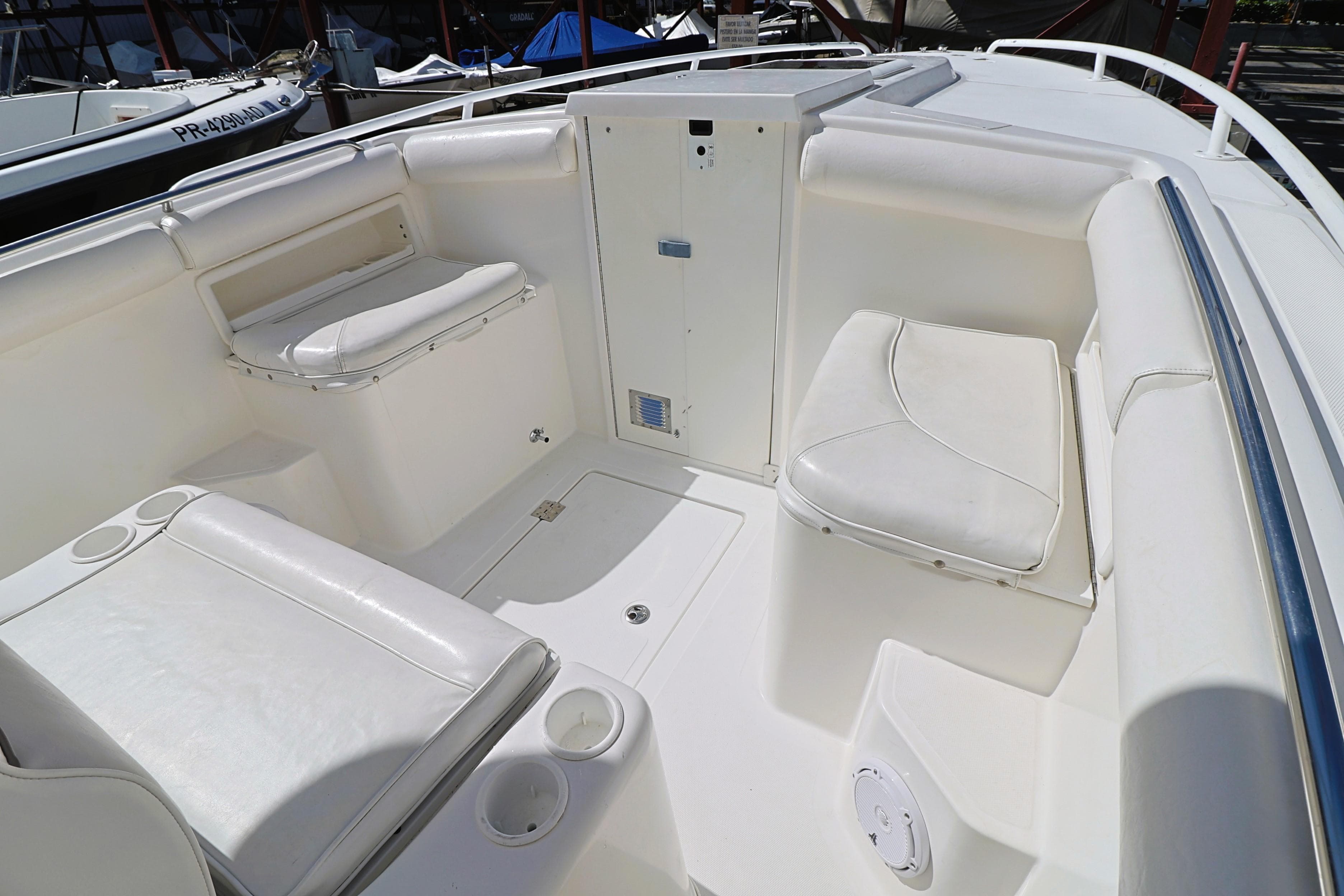 2004 Marlago 35 Sport Cuddy boat interior with white seating and storage compartments.