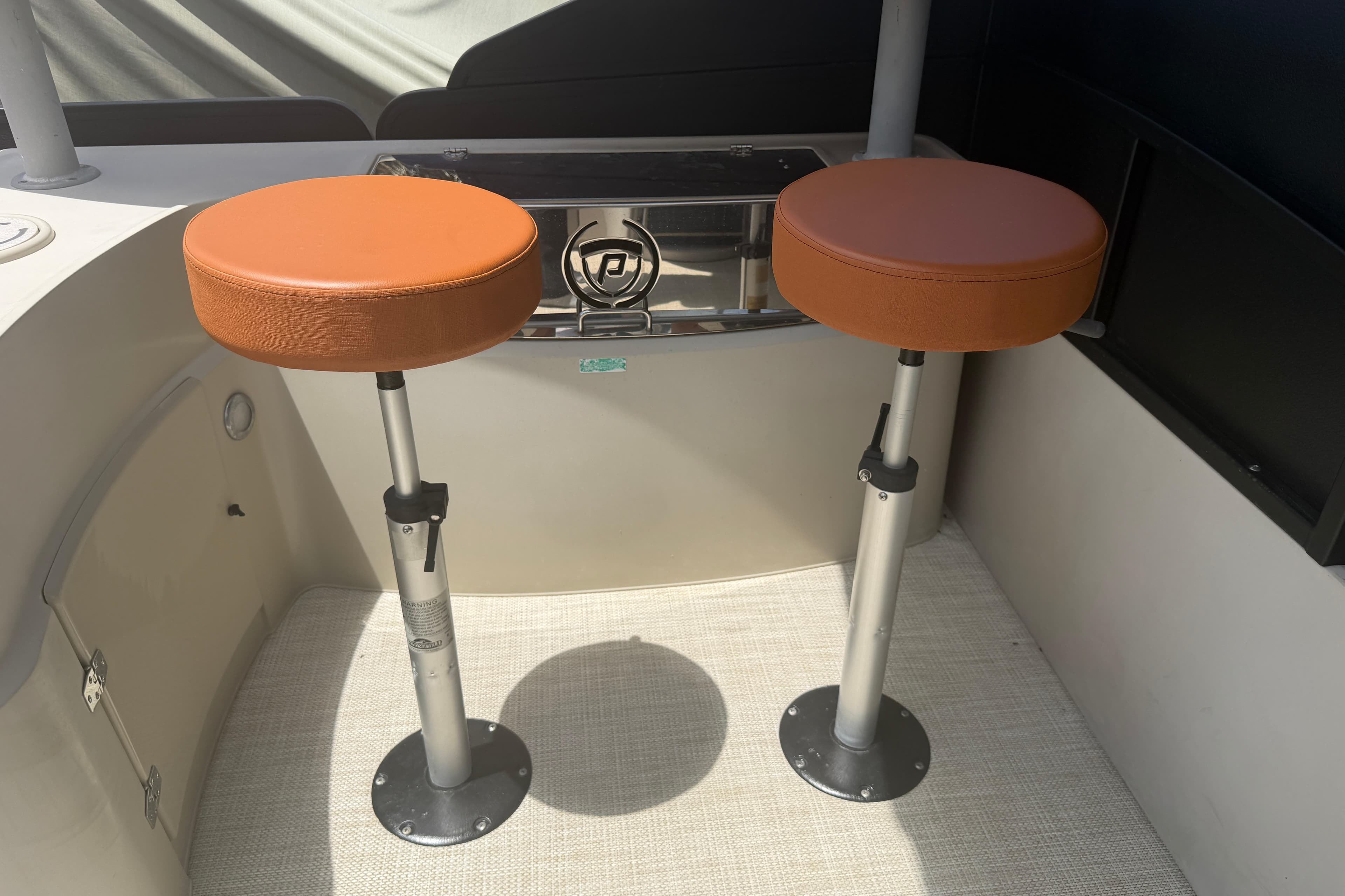 Two orange bar stools on a 2015 Premier 290 Grand View boat.