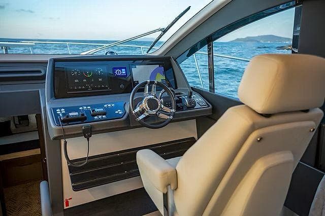 Helm of 2026 Schaefer 600 yacht with modern controls and ocean view.
