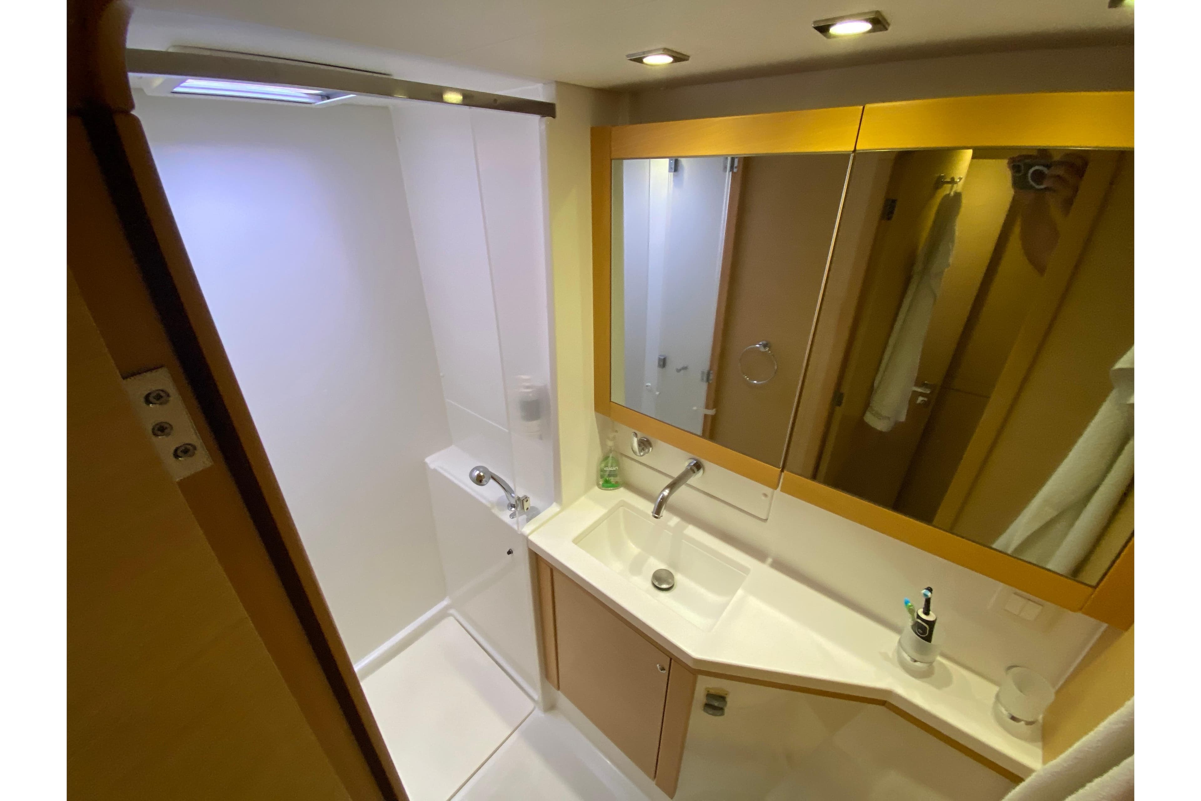 Bathroom interior of 2015 Lagoon 450 F yacht with modern fixtures and ample lighting.