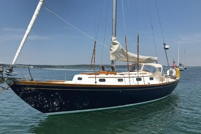 1964 Hinckley Pilot 35 Sloop sailing on calm waters under a clear blue sky.
