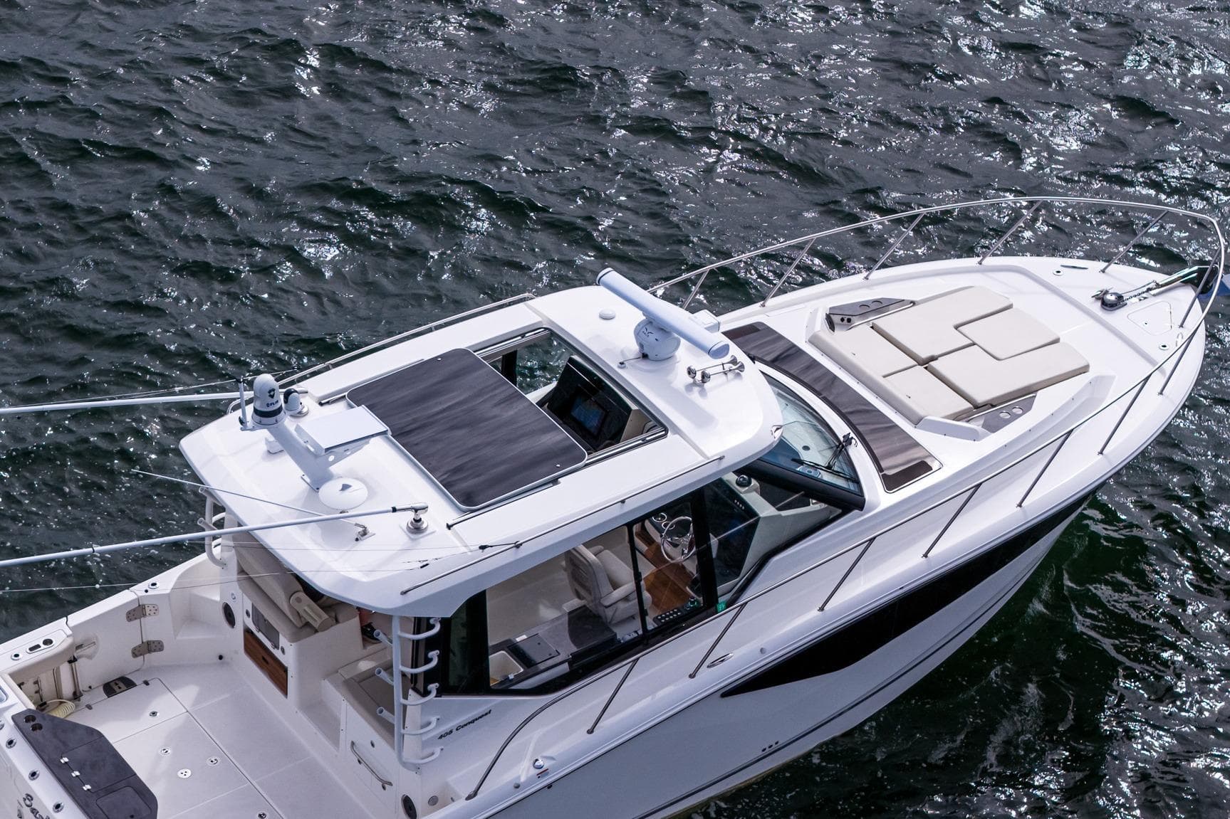2024 Boston Whaler 405 Conquest boat on water, aerial view of deck and cabin.