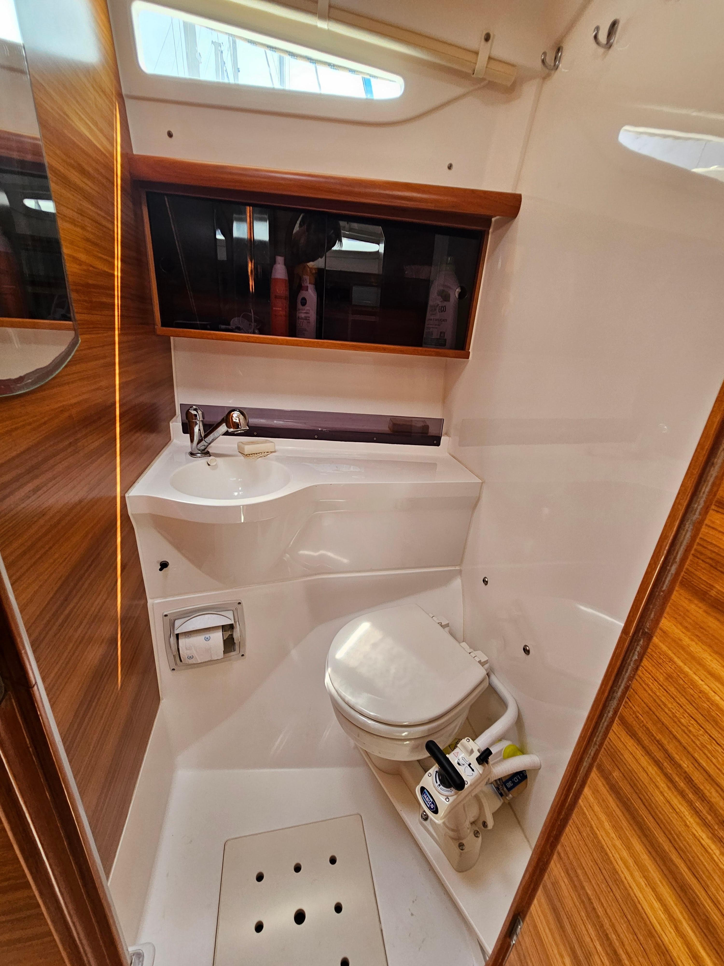 Compact bathroom in 2018 Dragonfly 32 Supreme yacht with wooden accents and modern fixtures.