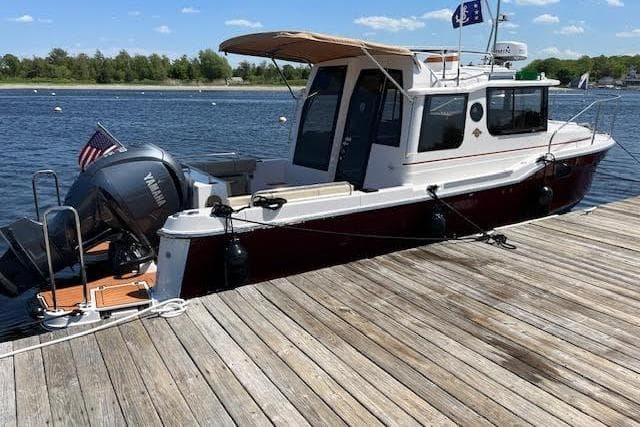 2022 Ranger Tugs R-25 boat docked on a sunny day with clear skies.