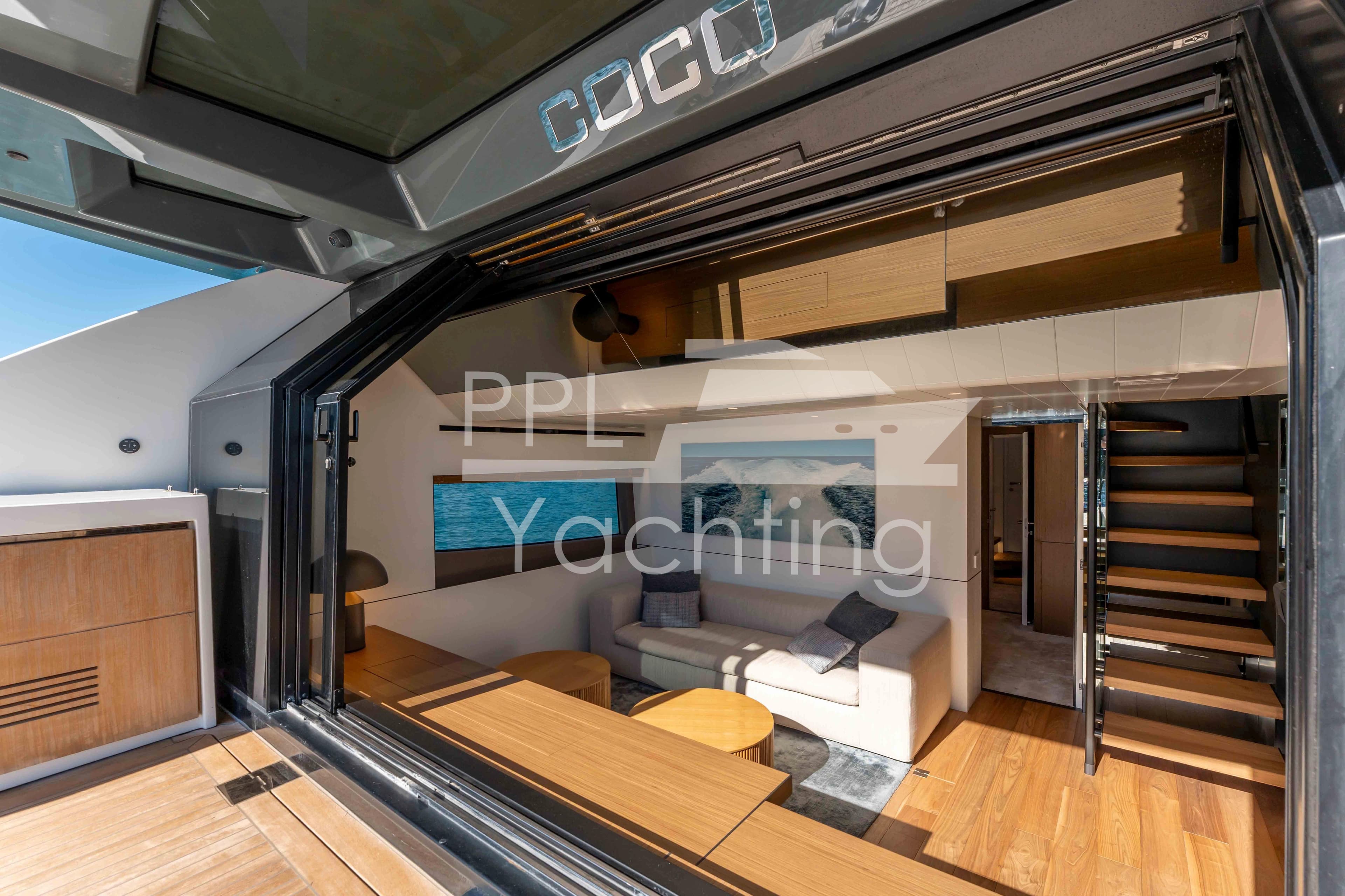 Luxurious interior of 2024 Bluegame BGX63 yacht with modern design and wooden flooring.