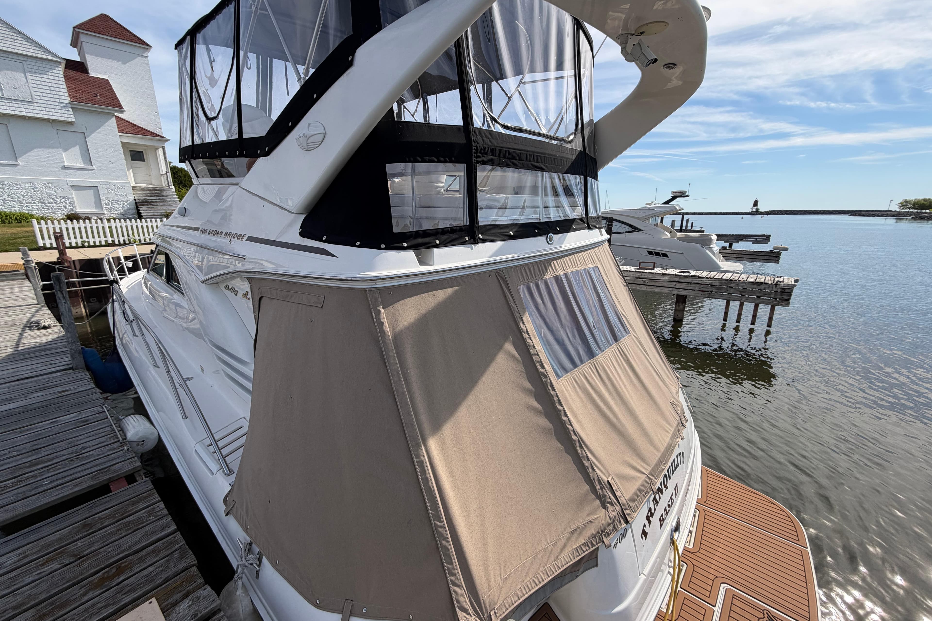 2000 Sea Ray 400 Sedan Bridge yacht docked by a serene waterfront.