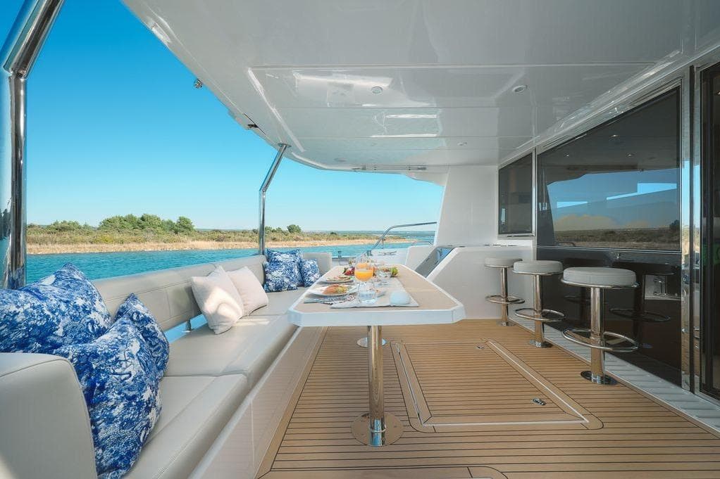 Luxurious 2024 Aquila 54 Yacht deck with elegant seating and scenic water view.