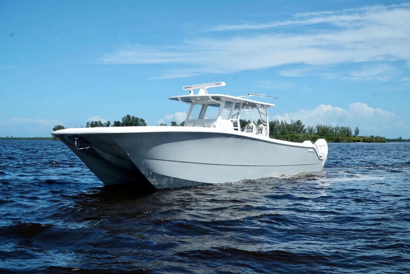 2021 Invincible 46 Catamaran cruising on open water under a clear blue sky.