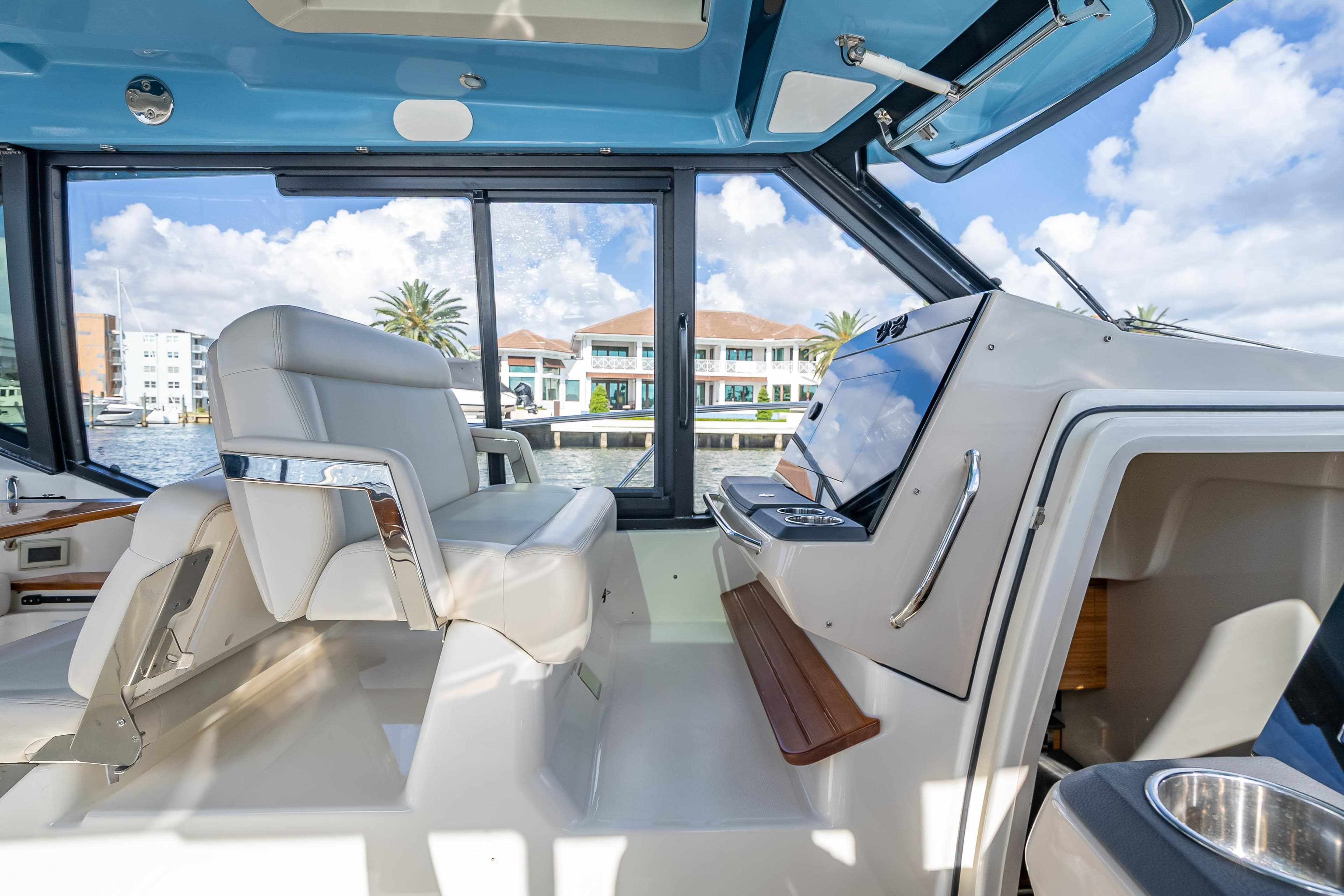 Interior of 2021 Boston Whaler 405 Conquest boat with luxurious seating and helm.