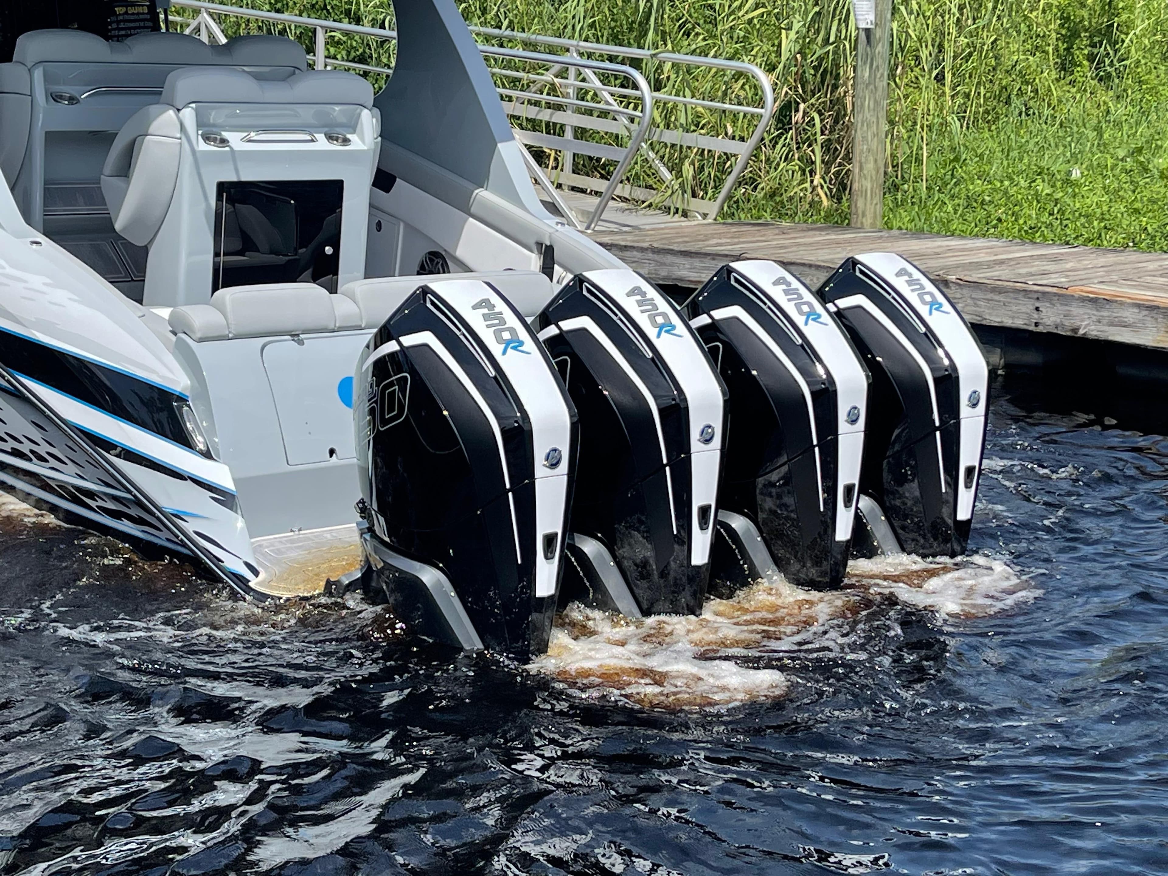 2022 Mystic Powerboats M3800 with four powerful outboard engines in water.