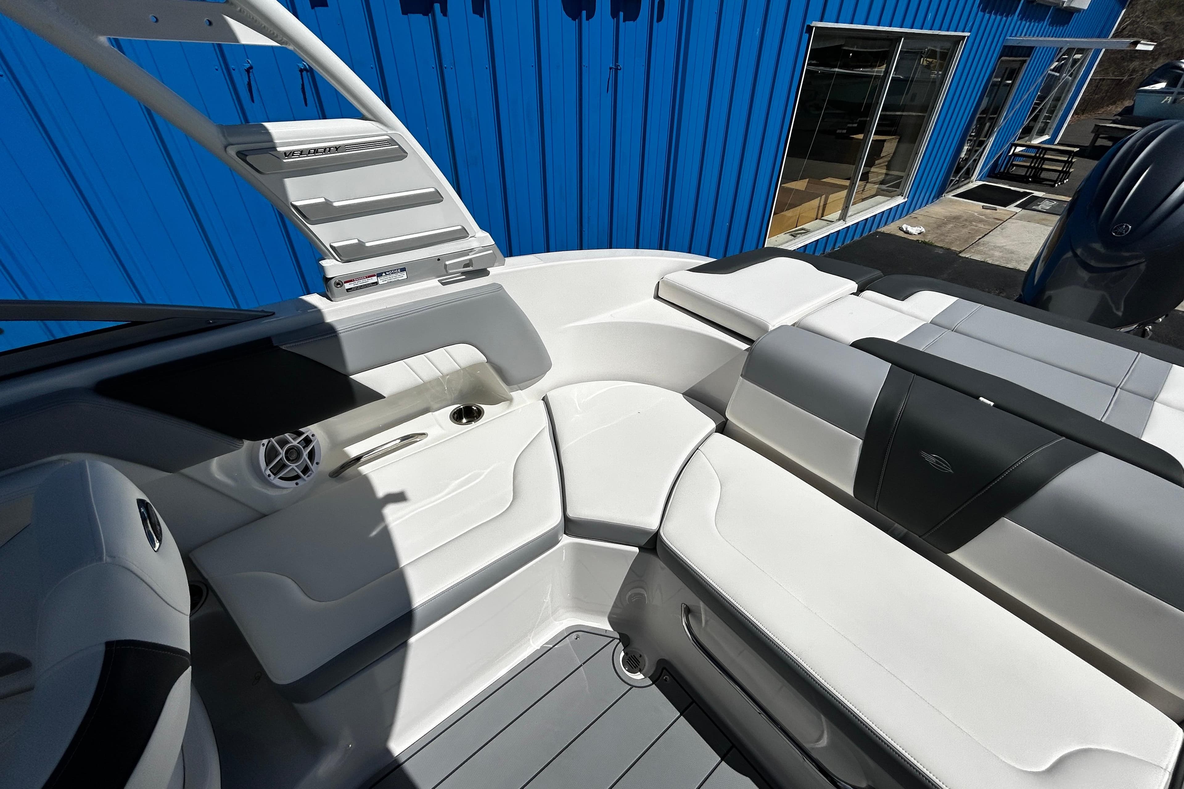 2025 Chaparral 23 SSi OB boat interior with white seating and modern design.