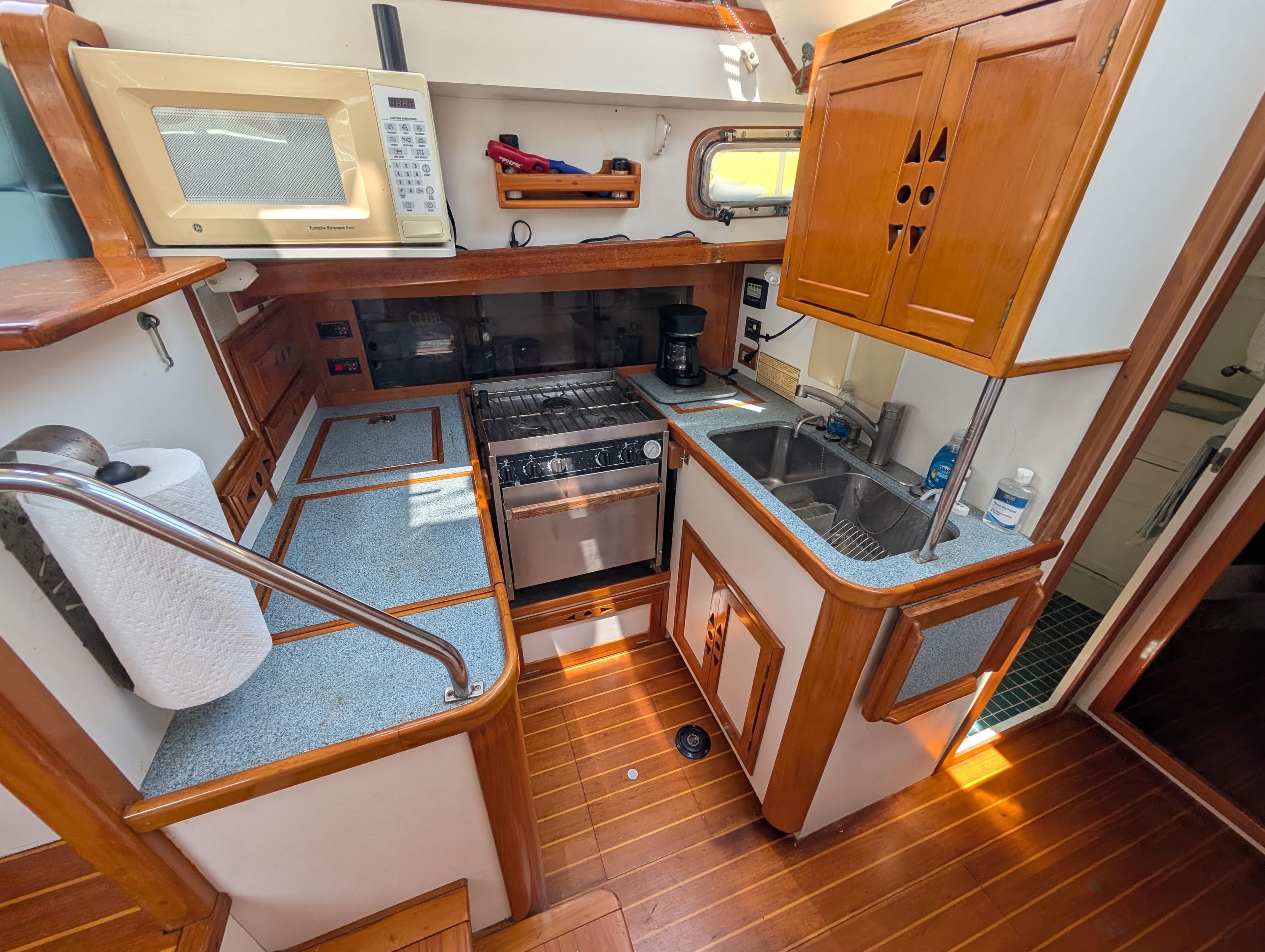 Cozy 1996 Cabo Rico Northeast 400 yacht kitchen with wood accents and modern appliances.