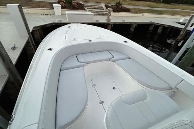2025 Contender 26 Bay boat with spacious seating at dock.