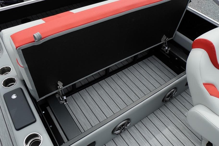 Open storage compartment in 2026 SunCatcher Select 322SL boat with cup holders and seating.